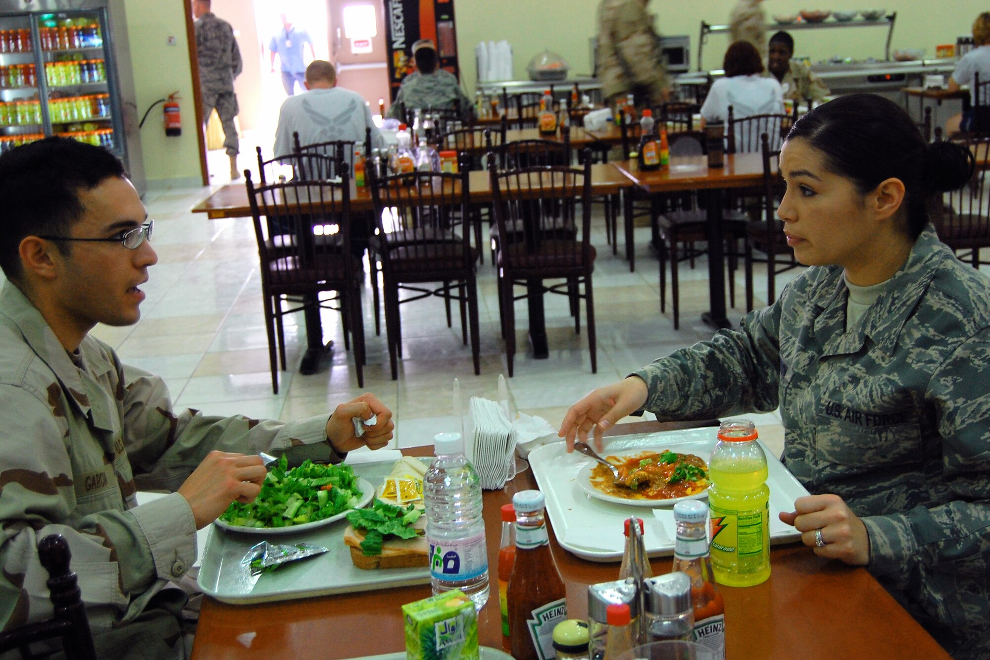 Senior Airman Christina Stimpson and her cousin, Navy Seaman Anthony Garcia, spend the afternoon reminiscing and catching up at a base in Southwest Asia. Both were deployed in support of the war on terror. Airman Stimpson is a financial management specialist deployed from Robins Air Force Base, Ga. Seaman Garcia is a hospital corpsman from Naval Air Station Patuxent River, Md. (U.S. Air Force photo/Staff Sgt. Patrick Dixon) 