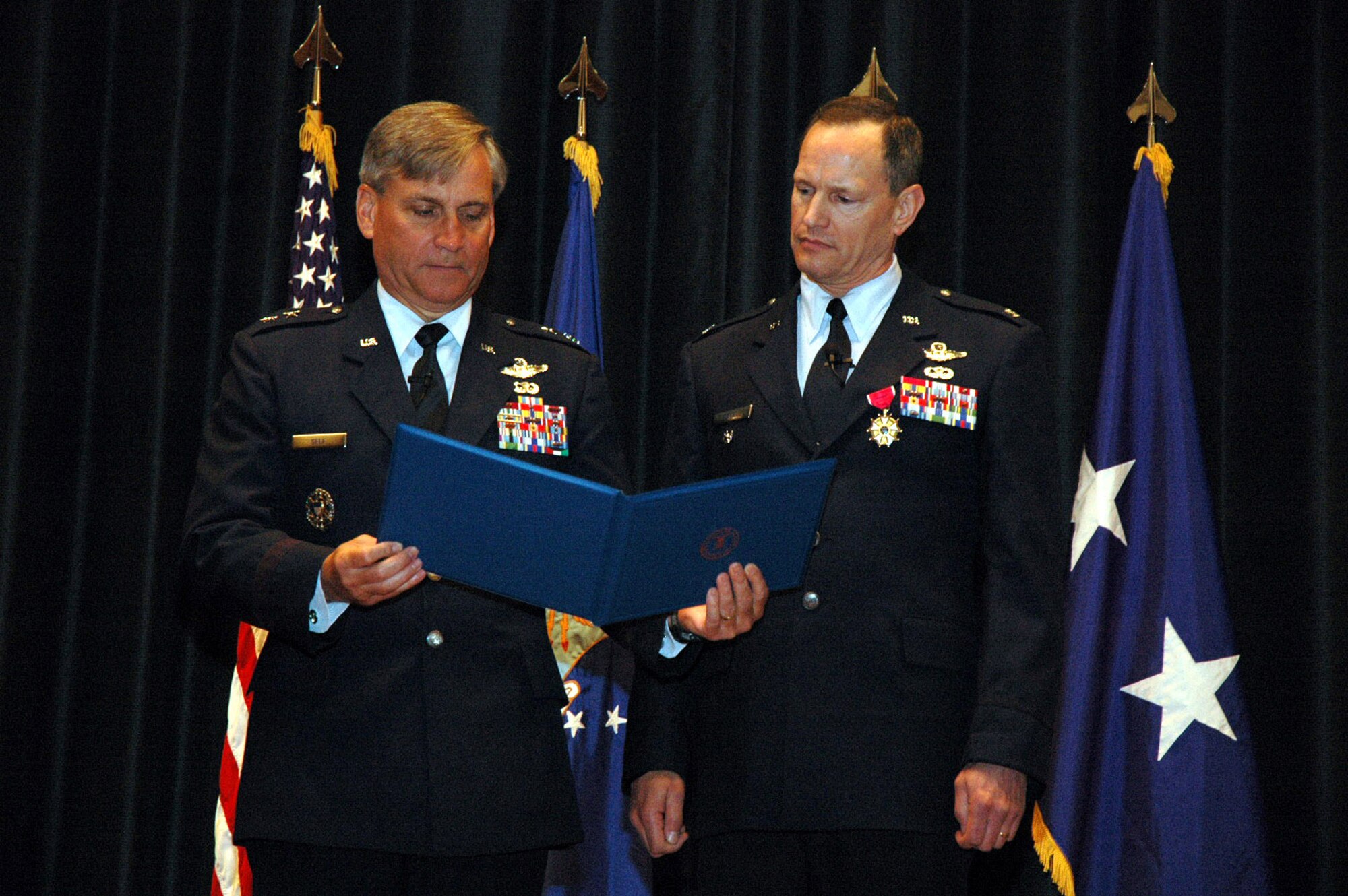 Maj. Gen. Kip Self, U.S. Air Force Expeditionary Center commander, and Col. Chuck Stiles, USAF EC vice commander, read over Colonel Stiles' retirement certificate from President George W. Buch during his retirement May 22, 2008, in the USAF EC's Grace Peterson Hall on Fort Dix, N.J.  General Self served as the presiding officer for the ceremony. Colonel Stiles retired with 30 years of service in the Air Force.  Both General Self and Colonel Stiles were 1978 graduates in the U.S. Air Force Academy.  (U.S. Air Force Photo/Tech. Sgt. Scott T. Sturkol)