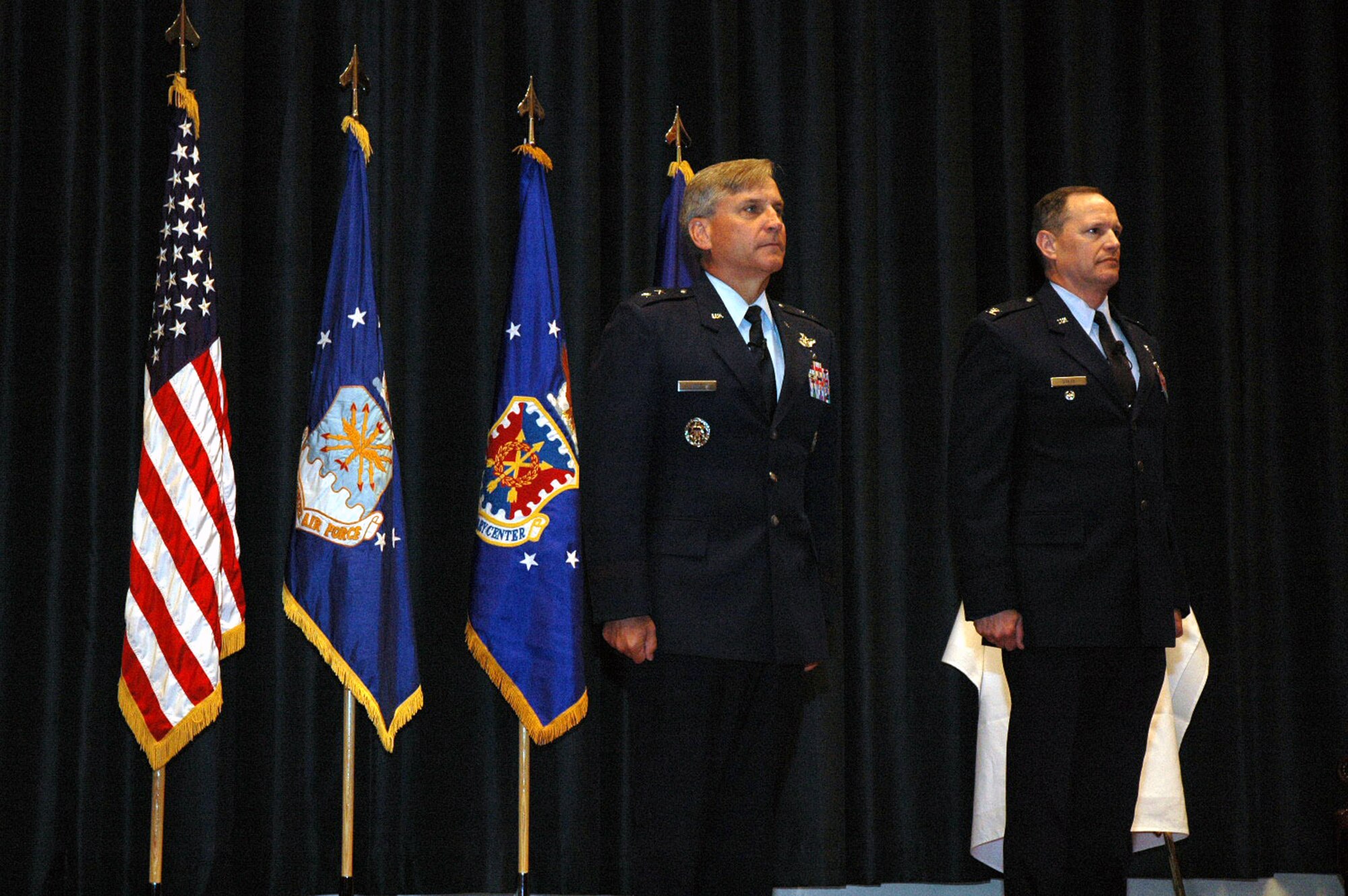 Maj. Gen. Kip Self, U.S. Air Force Expeditionary Center commander, and Col. Chuck Stiles, USAF EC vice commander, stand at attention during the reading of the orders for the presentation of the Legion of Merit to Colonel Stiles during his retirement May 22, 2008, in the USAF EC's Grace Peterson Hall on Fort Dix, N.J.  General Self served as the presiding officer for the ceremony. Colonel Stiles retired with 30 years of service in the Air Force.  Both General Self and Colonel Stiles were 1978 graduates in the U.S. Air Force Academy.  (U.S. Air Force Photo/Tech. Sgt. Scott T. Sturkol)