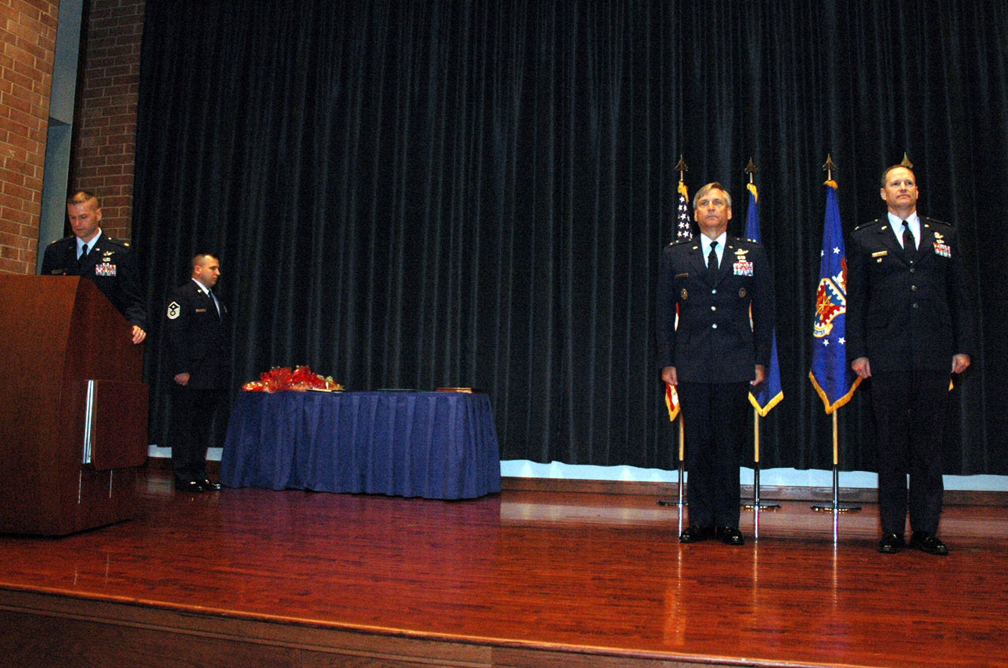 Maj. Gen. Kip Self, U.S. Air Force Expeditionary Center commander, and Col. Chuck Stiles, USAF EC vice commander, stand at attention during the reading of the orders by Maj. Phil Heseltine, USAF EC executive officer, for the presentation of the Legion of Merit to Colonel Stiles during his retirement May 22, 2008, in the USAF EC's Grace Peterson Hall on Fort Dix, N.J.  General Self served as the presiding officer for the ceremony. Colonel Stiles retired with 30 years of service in the Air Force.  Both General Self and Colonel Stiles were 1978 graduates in the U.S. Air Force Academy.  (U.S. Air Force Photo/Tech. Sgt. Scott T. Sturkol)