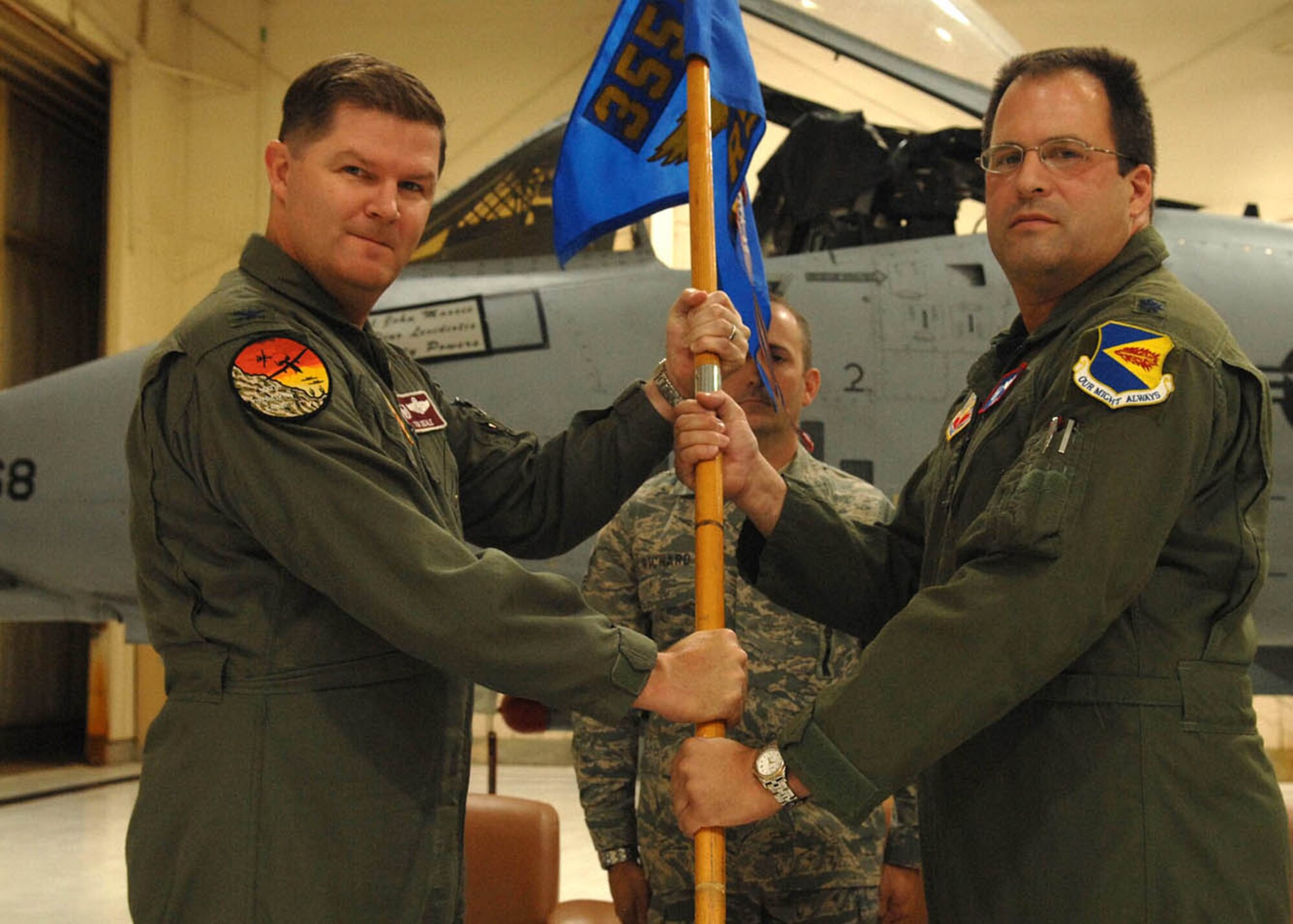 Col. Thomas Deale,left, 355th Operations Group commander, passes the guideon to Lt. Col. David Ide at a chain of command ceremony for the 355th Training Squadron here May 28.  Colonel Ide takes command as Lt.Col. John Massee leaves to take new challenge at 12th Air Force (Air Forces Southern). Colonel Ide was the former Chief of Safety for the 355th Fighter Wing.  (U.S. Air Force photo by Senior Airman Jacqueline Hawkins)