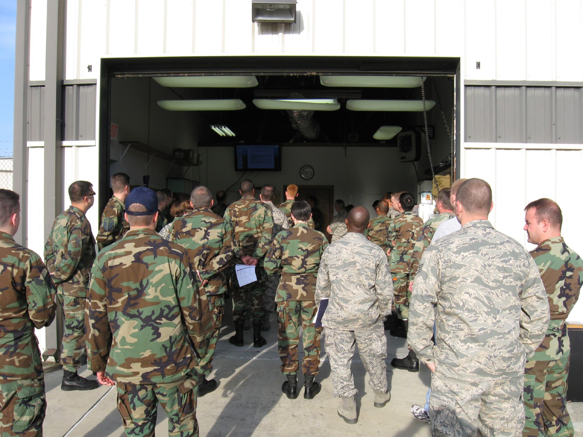 SEYMOUR JOHNSON AIR FORCE BASE, N.C. -- Members of the 916th Communication Squadron gather around as Staff Sgt. Roger Foreman teaches about corrosion prevention of equipment during the May unit training assembly. The briefing was so popular that it allowed for standing room only.