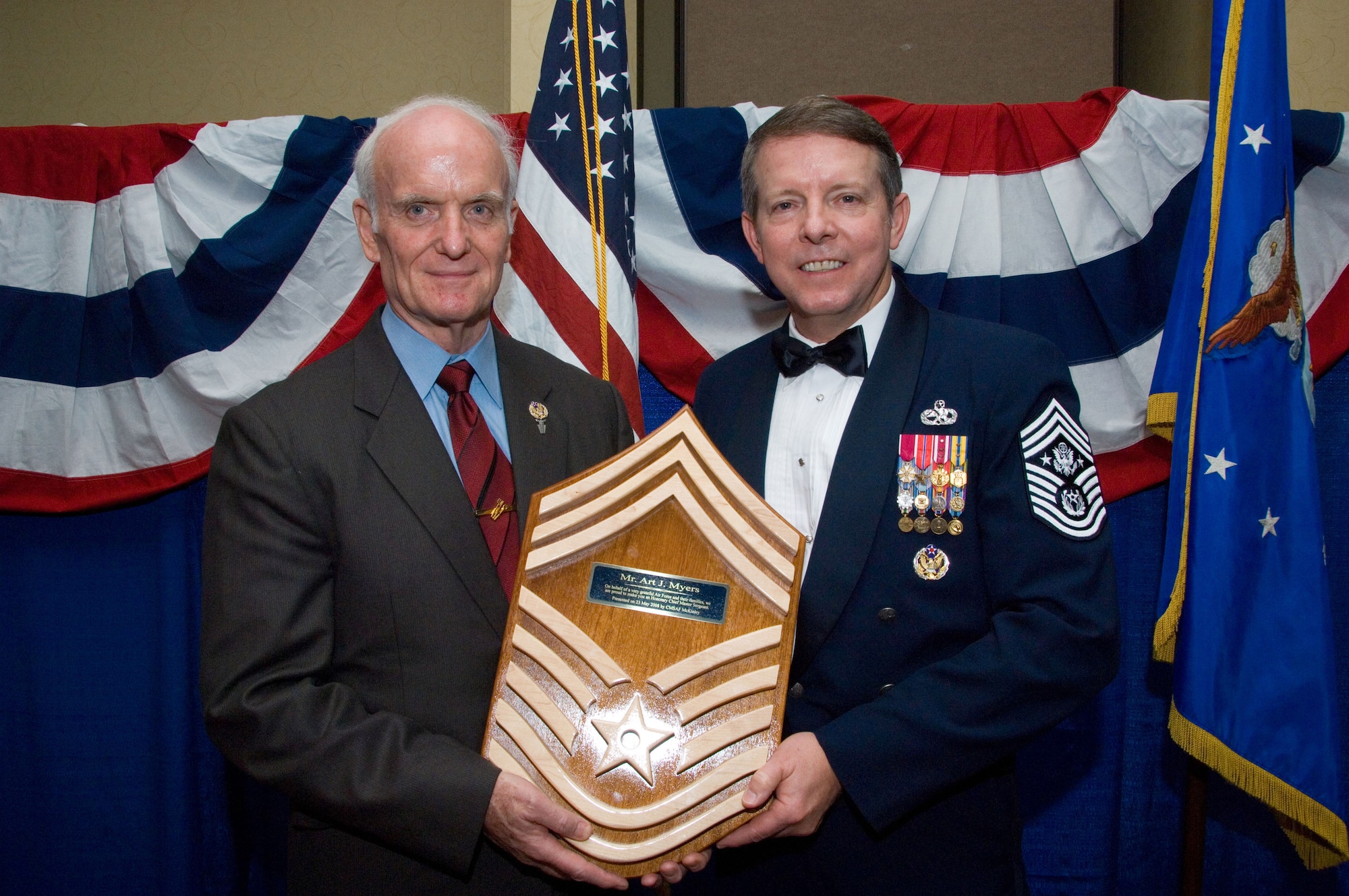 Chief Master Sgt. of the Air Force Rodney J. McKinley presents Arthur J. Myers, director of Air Force Services, with the honorary rank and title of a chief master sergeant in the Air Force during the Enlisted Heritage Dinner May 23 at the Senior Enlisted Leaders Summit in Montgomery, Ala.  (U.S. Air Force photo/Melanie E. Rodgers)
