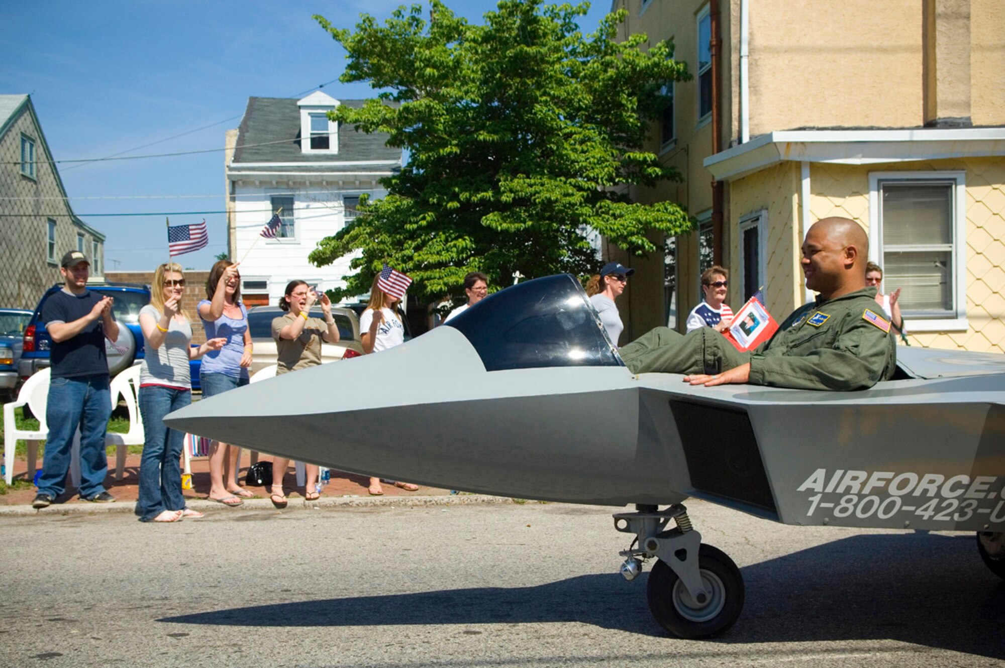 Staff Sgt. Paul Salter drives a motorized version of the F-22 Raptor during the Bridesburg Memorial Day Parade May 26. Bridesburg is a borough in Philadelphia and hosted the kickoff celebrations for Air Force Week Philadelphia. Air Force Week Philadelphia is an event designed to build new relationships in the Philadelphia metropolitan area and strengthen public support for the Air Force mission and Airmen serving worldwide in the war on terrorism. Sergeant Salter is assigned to the 305th Security Forces Squadron at McGuire Air Force Base, N.J.  (U.S. Air Force photo/Staff Sgt. Bennie J. Davis III)