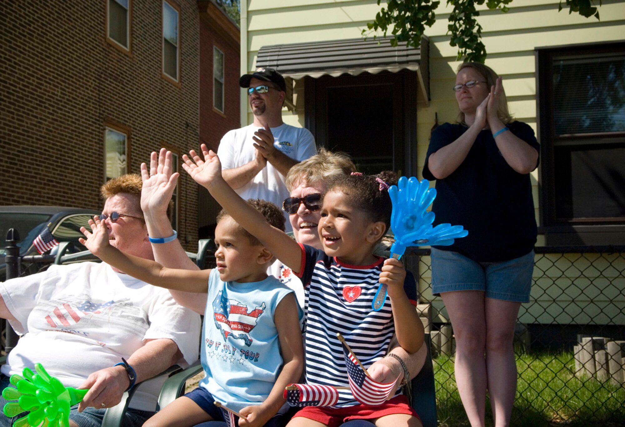 Kiyoan and Akeem Thorton (center) sit on their grandmother's lap, cheering Airmen participating in the Bridesburg Memorial Day Parade May 26. Bridesburg is a borough in Philadelphia and hosted the kickoff celebrations for Air Force Week Philadelphia. Air Force Week Philadelphia is an event designed to build new relationships in the Philadelphia metropolitan area and strengthen public support for the Air Force mission and Airmen serving worldwide in the war on terrorism.  (U.S. Air Force photo/Staff Sgt. Bennie J. Davis III)