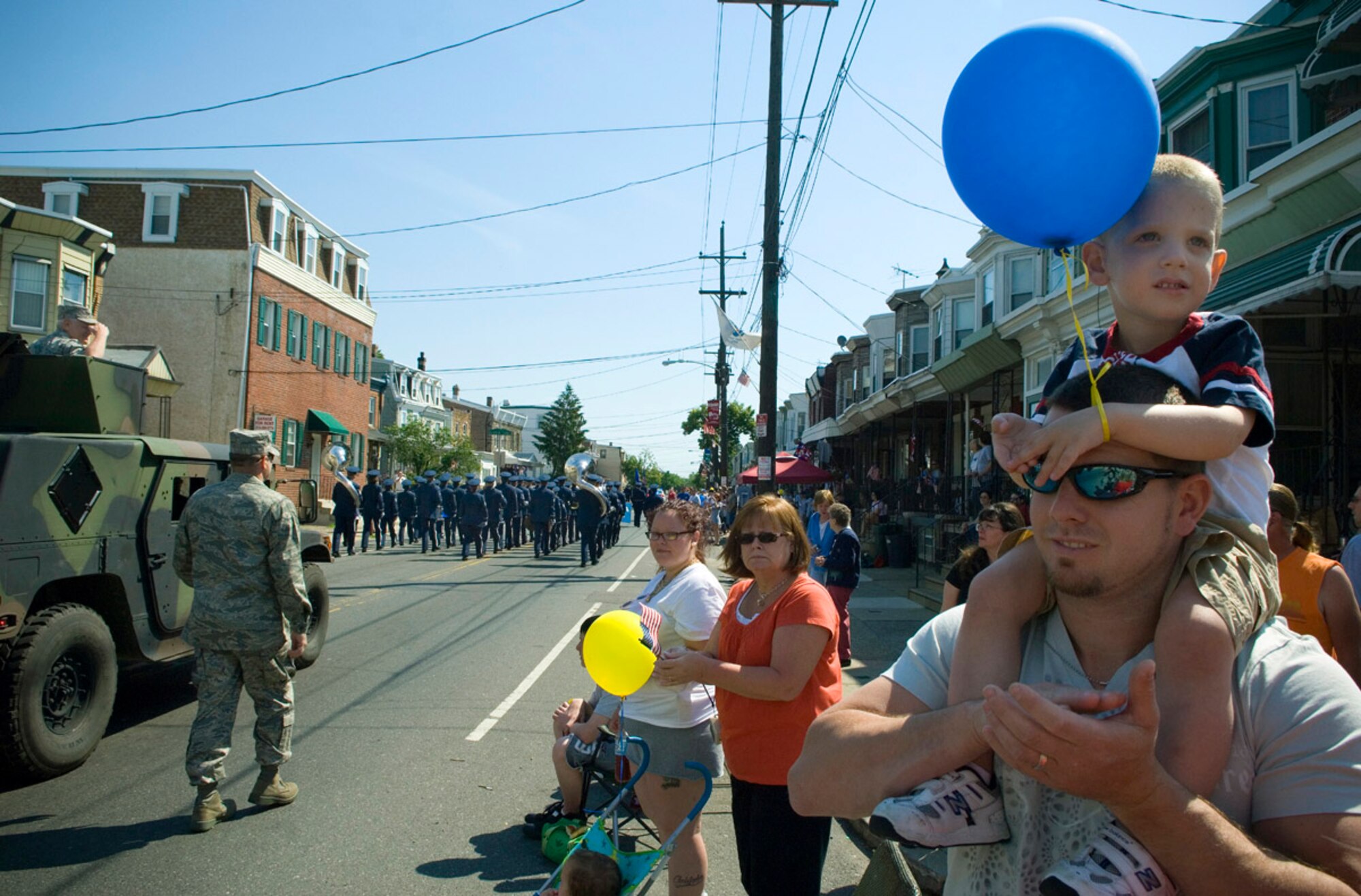 Larry Rose Jr., 3, sits upon his dad's shoulders watching the Bridesburg Memorial Day Parade May 26. Bridesburg is a borough in Philadelphia and hosted the kickoff celebrations for Air Force Week Philadelphia. The parade featured a fly-by of a KC-135 Stratotanker and a KC-10 Extender and a performance by the U.S. Air Force Heritage of America Band. Air Force Week Philadelphia is an event designed to build new relationships in the Philadelphia metropolitan area and strengthen public support for the Air Force mission and Airmen serving worldwide in the war on terrorism. (U.S. Air Force photo/Staff Sgt. Bennie J. Davis III)
