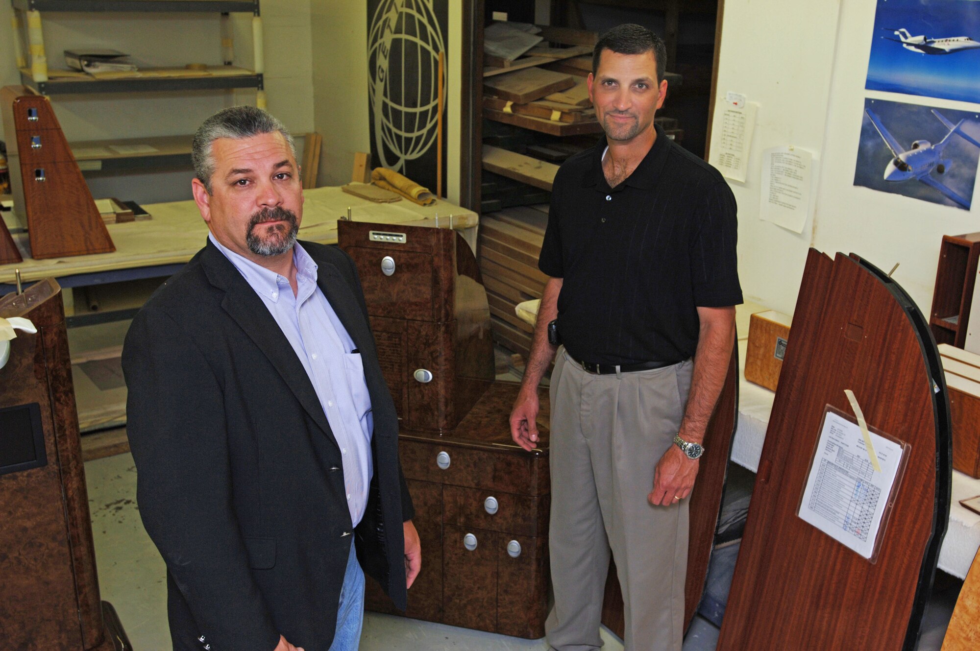 Senior Master Sgt. Kurt Smith (on right) and his civilian boss, Randall Salyer, stand in the shop where Sergeant Smith started when he was hired at Global Engineering and Technology, Inc., ten years ago.  Salyer is Global's president and Sergeant Smith has worked his way up to become Salyer's director of operations.  Sergeant Smith is an engineering superintendent for the 931st Civil Engineer Squadron.


