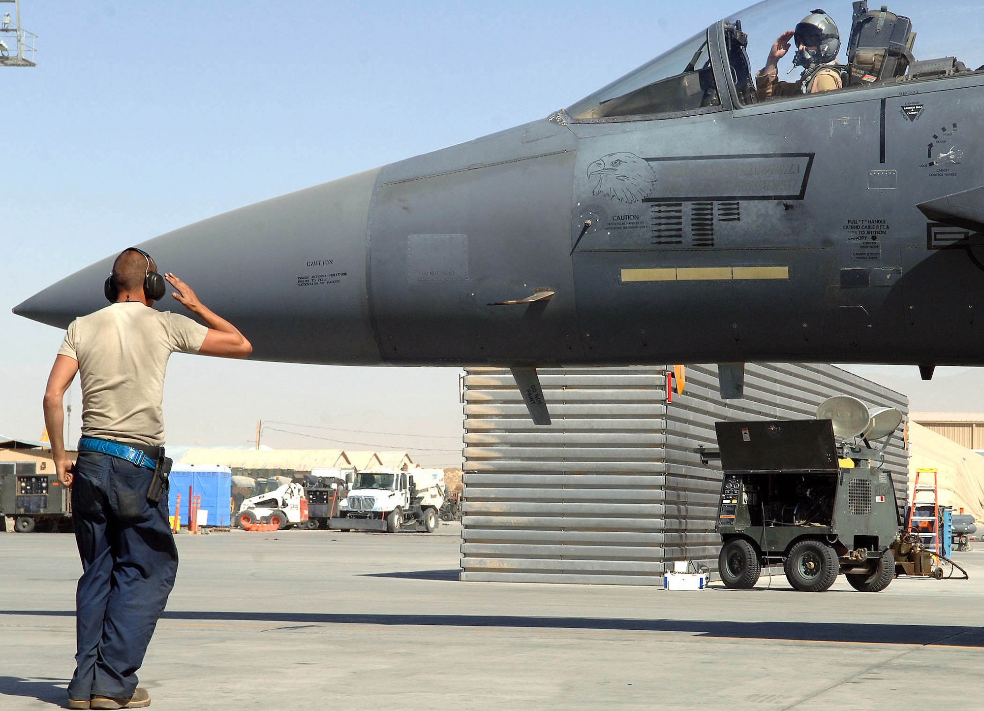 An F-15E Strike Eagle crew chief salutes the pilot prior to his flight from Bagram Airfield, Afghanistan. The F-15Es are stationed here providing close-air support for troops on the ground. (U.S. Air Force photo/Staff Sgt. Craig Seals) 
