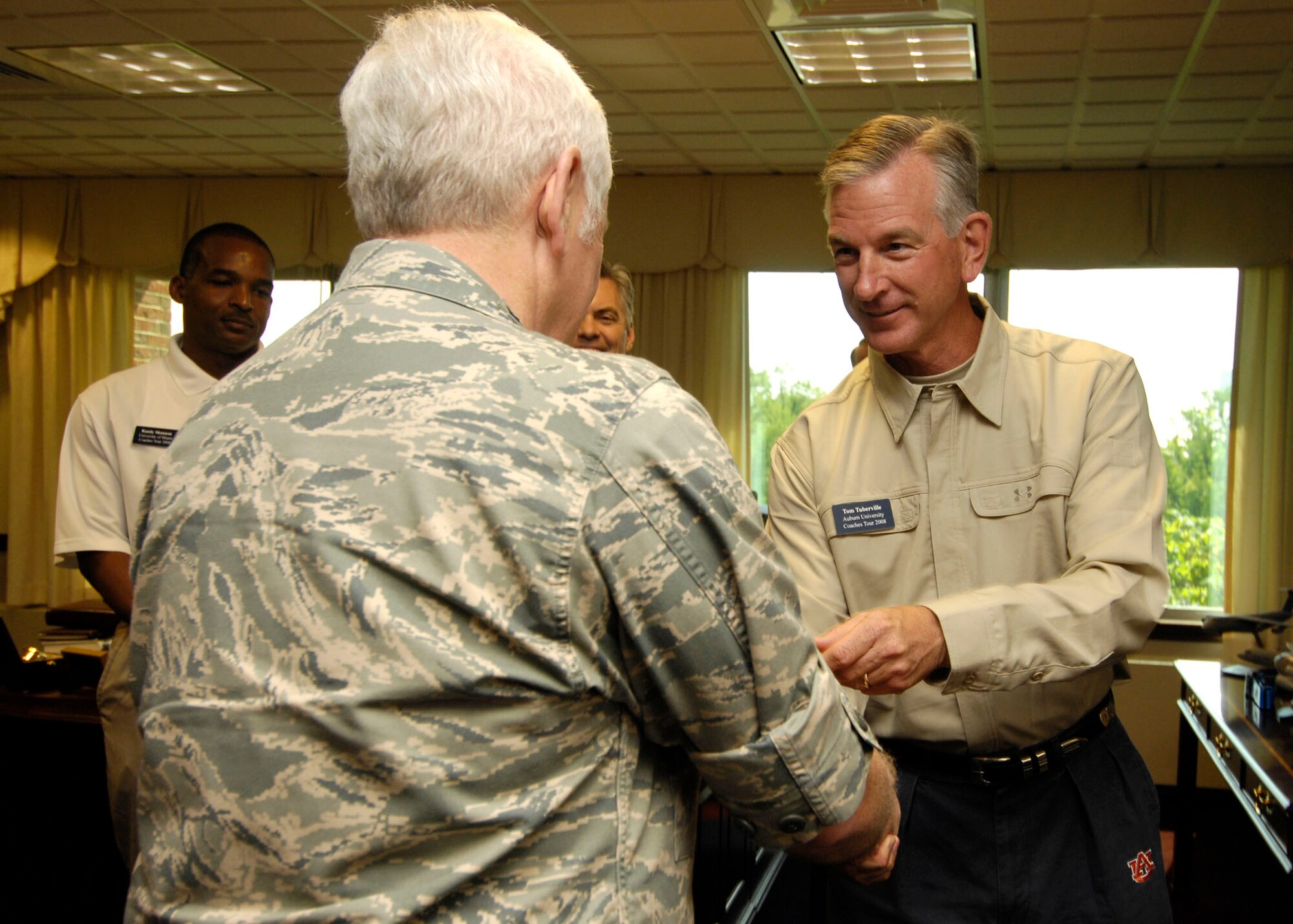 SCOTT AIR FORCE BASE, Ill. -- Gen. Arthur J. Lichte, Air Mobility Command commander, shakes hands with Tom Tuberville, football coach at Auburn University, May 20. Mr. Tuberville was one of five college football coaches to visit Scott Air Force Base before embarking on a trip to the Middle East see deployed servicemembers as part of Coaches Tour 2008. (U.S. Air Force photo/Senior Airman Mildred Guevara)