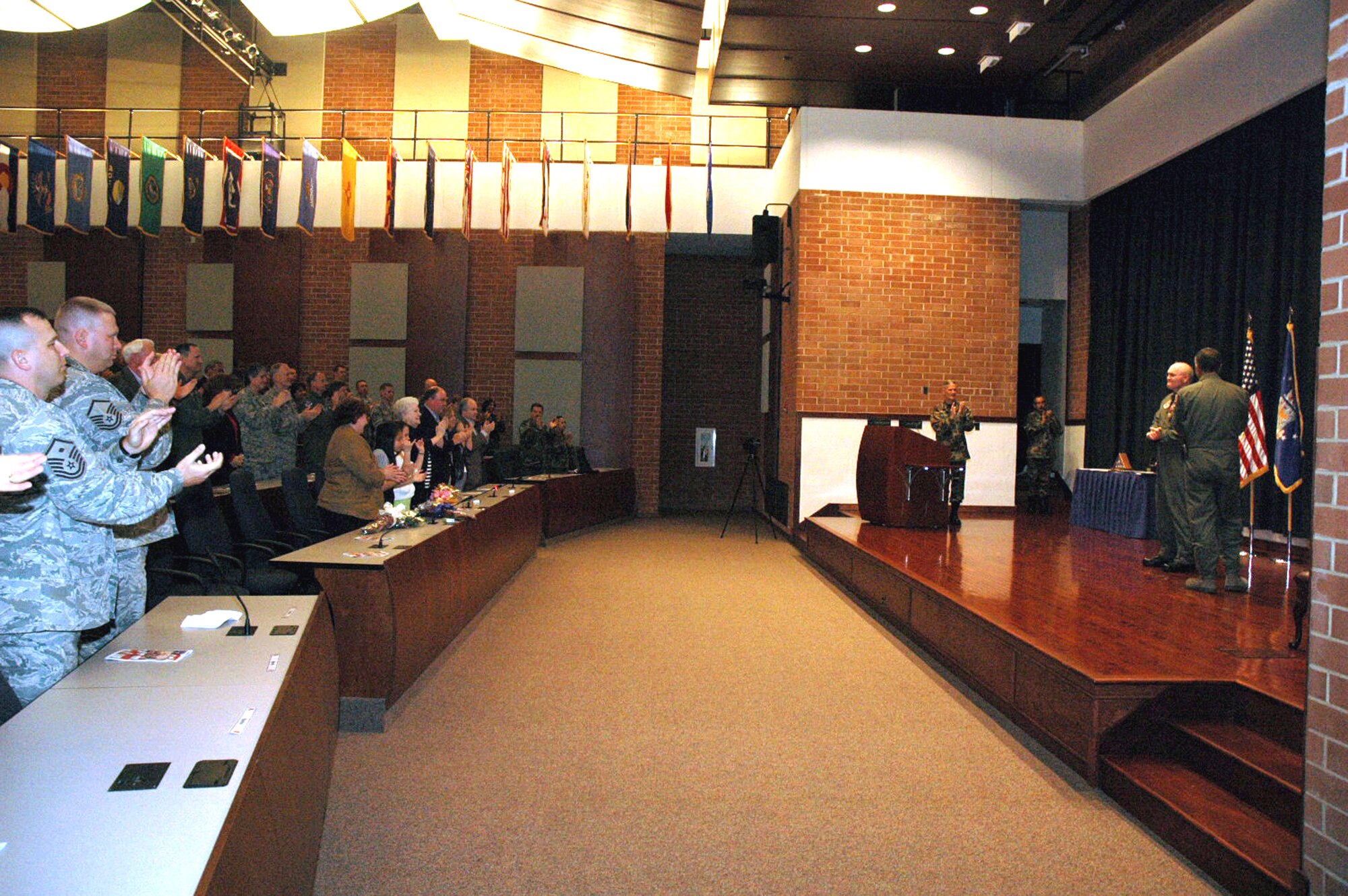 Col. Tracy Scott receives a standing ovation in appreciation for his 30 years of service during his retirement ceremony in the U.S. Air Force Expeditionary Center's Grace Peterson Hall May 16, 2008, on Fort Dix, N.J.  Maj. Gen. John Howlett, mobilization assistant to the commander of Air Mobility Command, Scott Air Force Base, Ill., was the presiding officer over the ceremony for Colonel Scott, mobilization assistant to the commander of the USAF EC.  (U.S. Air Force Photo/Tech. Sgt. Scott T. Sturkol)