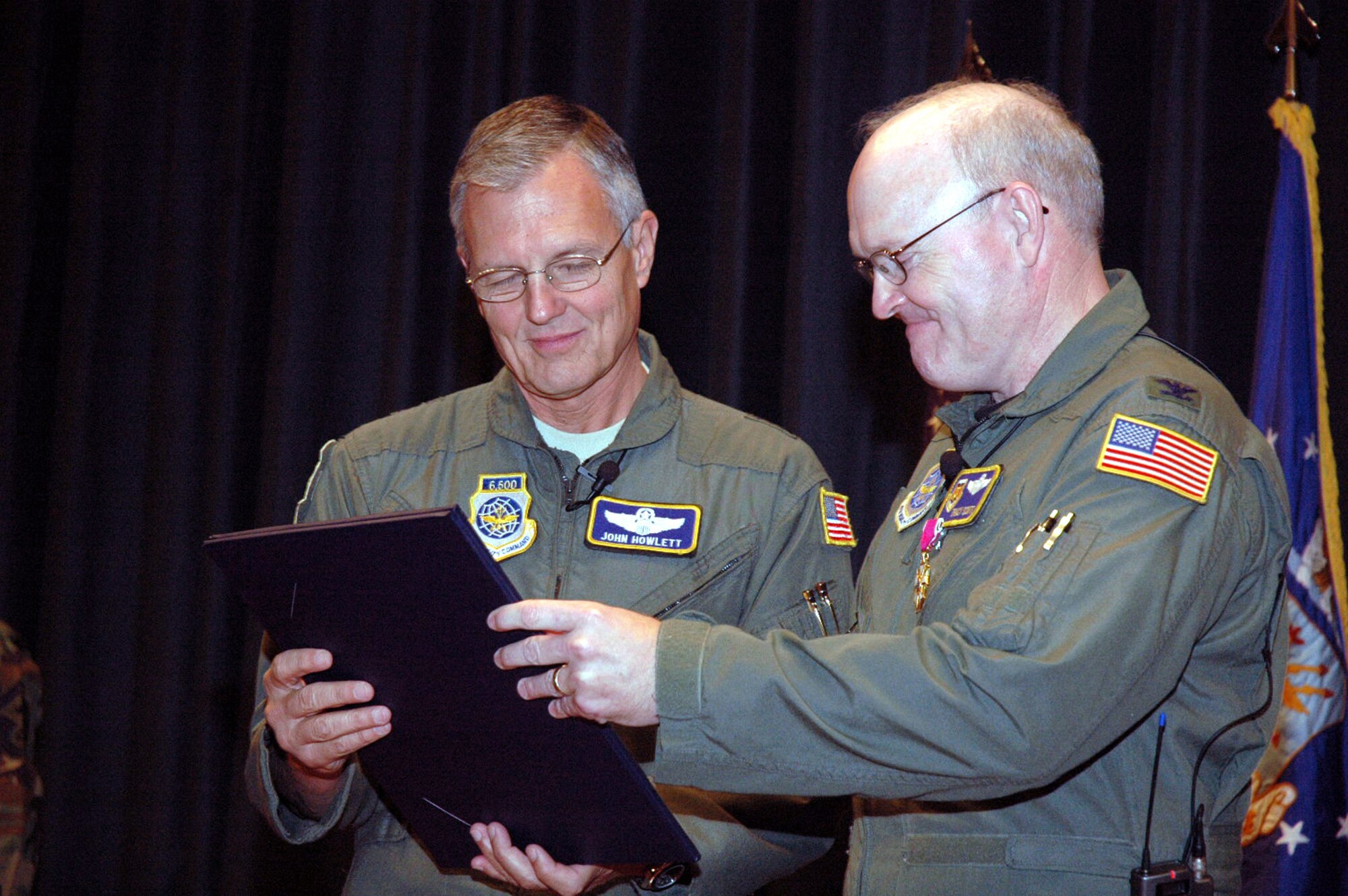 Maj. Gen. John Howlett and Col. Tracy Scott read over the retirement certificate for Colonel Scott from President George W. Bush during his retirement ceremony in the U.S. Air Force Expeditionary Center's Grace Peterson Hall May 16, 2008, on Fort Dix, N.J.  General Howlett, mobilization assistant to the commander of Air Mobility Command, Scott Air Force Base, Ill., was the presiding officer over the ceremony for Colonel Scott, mobilization assistant to the commander of the USAF EC, who retired after 30 years of service.  (U.S. Air Force Photo/Tech. Sgt. Scott T. Sturkol)