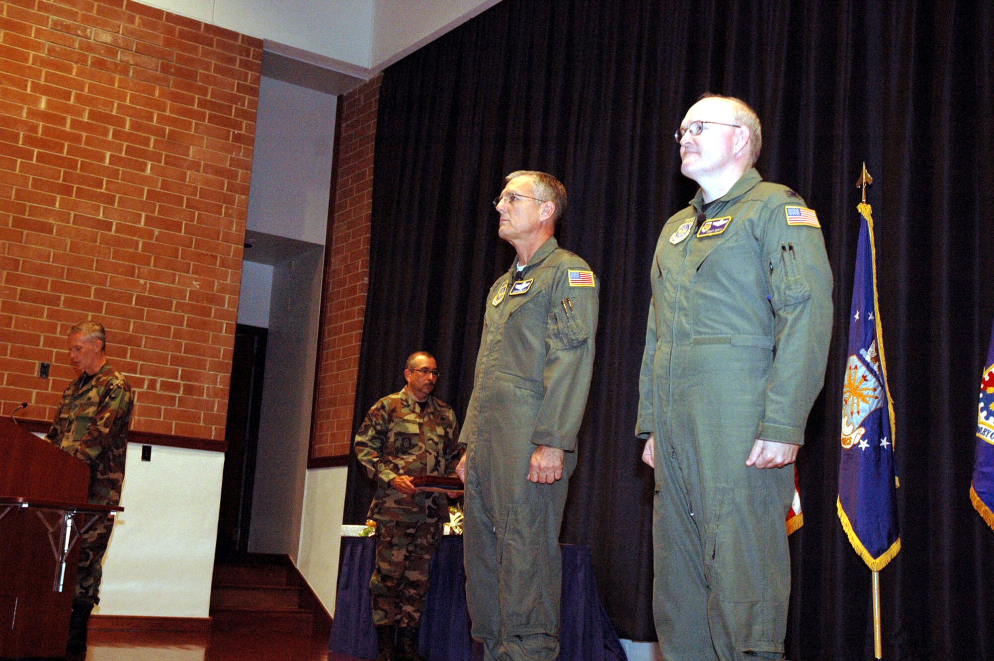 Maj. Gen. John Howlett and Col. Tracy Scott stand at attention during the reading of the orders for the award of the Legion of Merit to Colonel Scott during his retirement ceremony in the U.S. Air Force Expeditionary Center's Grace Peterson Hall May 16, 2008, on Fort Dix, N.J.  General Howlett, mobilization assistant to the commander of Air Mobility Command, Scott Air Force Base, Ill., was the presiding officer over the ceremony for Colonel Scott, mobilization assistant to the commander of the USAF EC, who retired after 30 years of service.  (U.S. Air Force Photo/Tech. Sgt. Scott T. Sturkol)