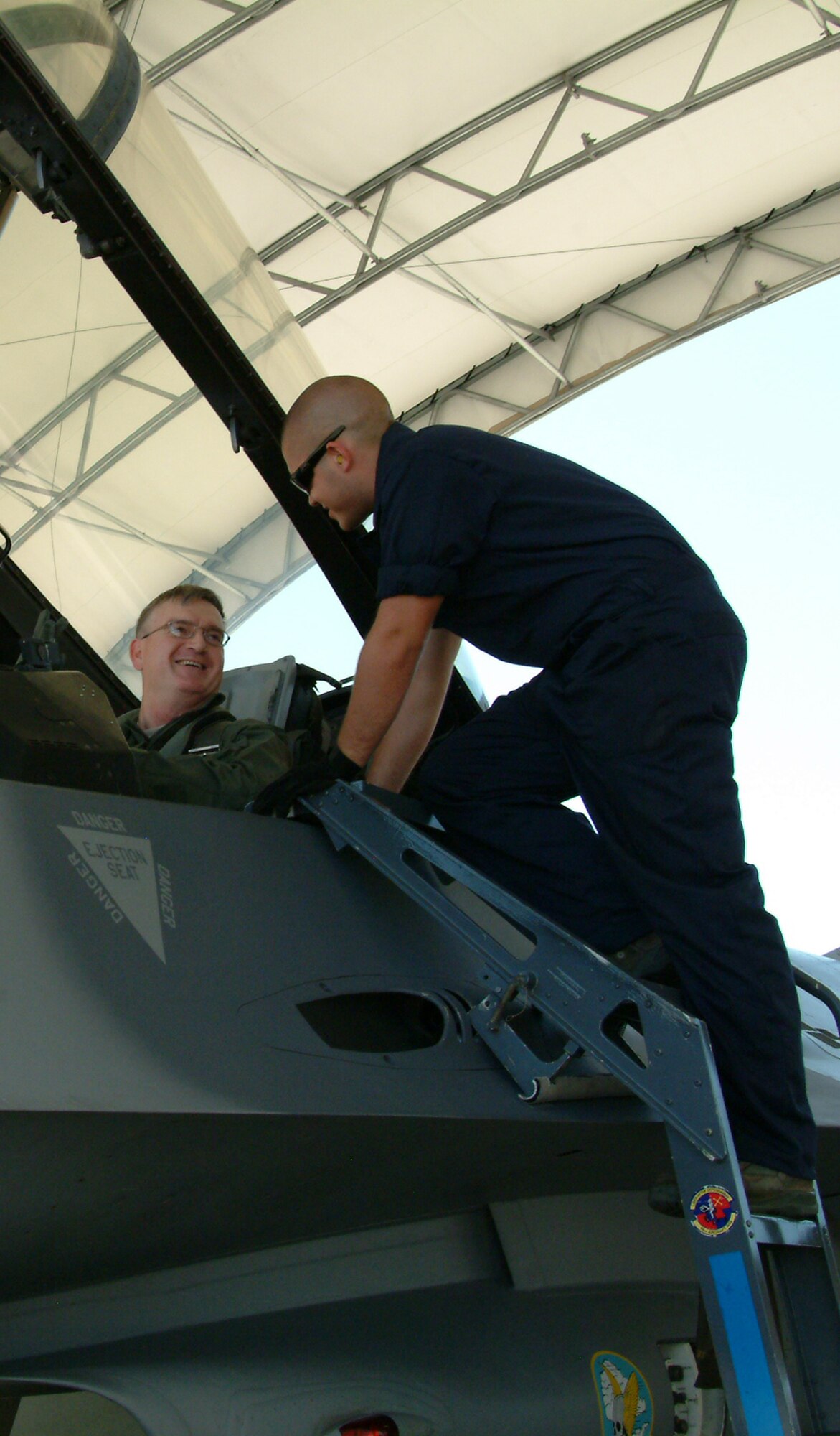 Chief Master Sgt. Randy Salefske, 53d Wing command chief, chats with a 46th Maintenance Group enlisted maintainer prior to his F-16 incentive flight May 28 at Eglin Air Force Base, Fla.  It was the first time the chief took to the skies in an Air Force fighter in his 30-year career.  The chief ended his career with the 53d Wing at a retirement ceremony May 30.  Photo by Staff Sgt. Samuel King Jr.