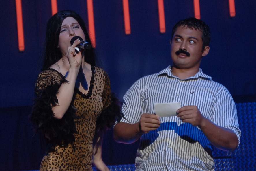 ABILENE, Texas -- Senior Airman April Vollm brings up a member of the audience to participate in the Tops in Blue show May 26 at the Abilene Civic Center. Airman Vollm a member of last years Tops in Blue team is a member of the 39th Airlift Squadron. (U.S. Air Force photo by Airman 1st Class Felicia Juenke)