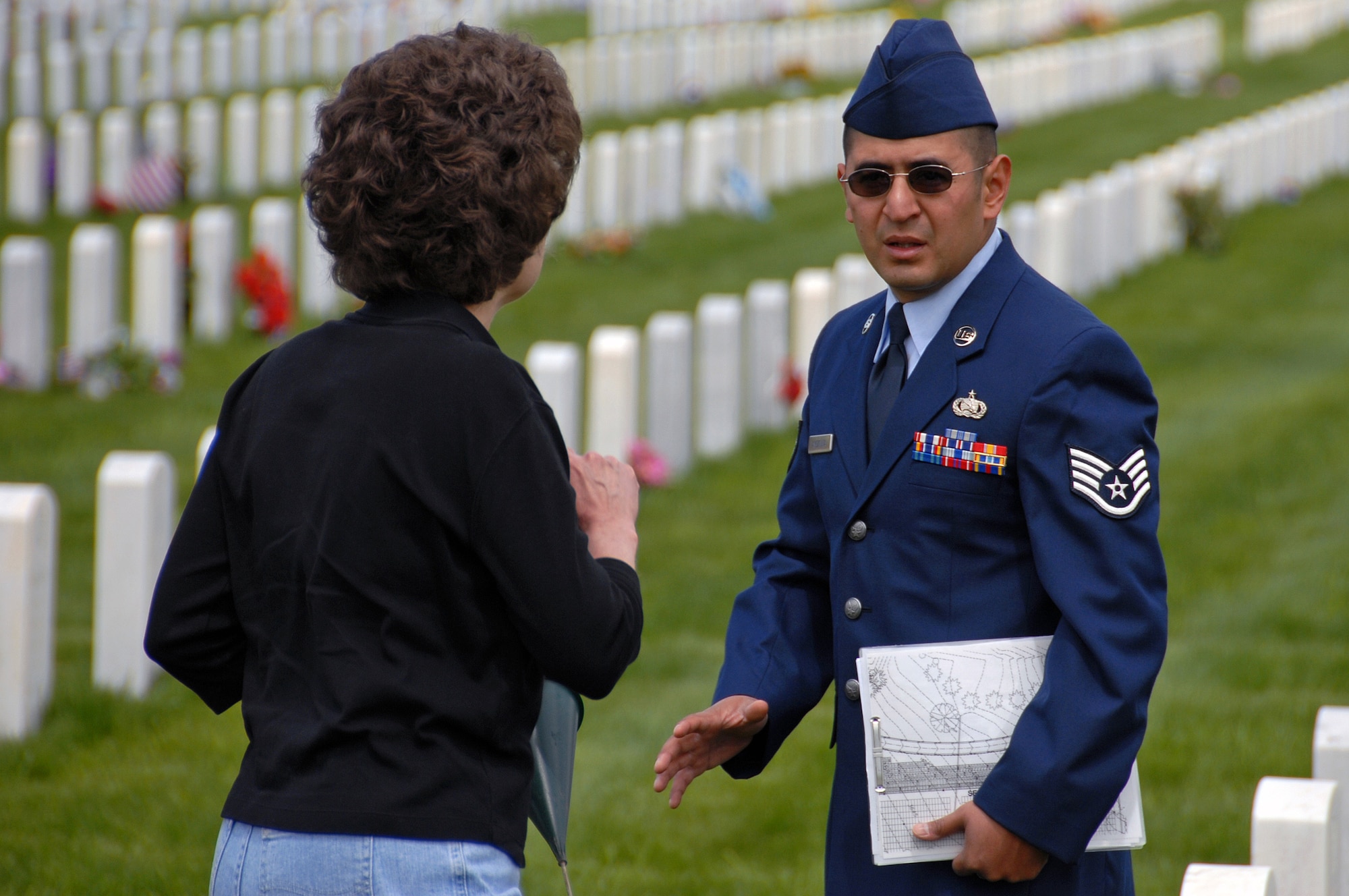 Staff Sgt. Michael Amezquita, 28th Communications Squadron help desk technician, locates graves of fallen military members for friends and family at the Black Hills National Cemetery, S.D., May 25. During the Memorial day weekend 114 people from Ellsworth volunteered to help the cemetery. (U.S. Air Force photo/Senior Airman Marc I. Lane)
