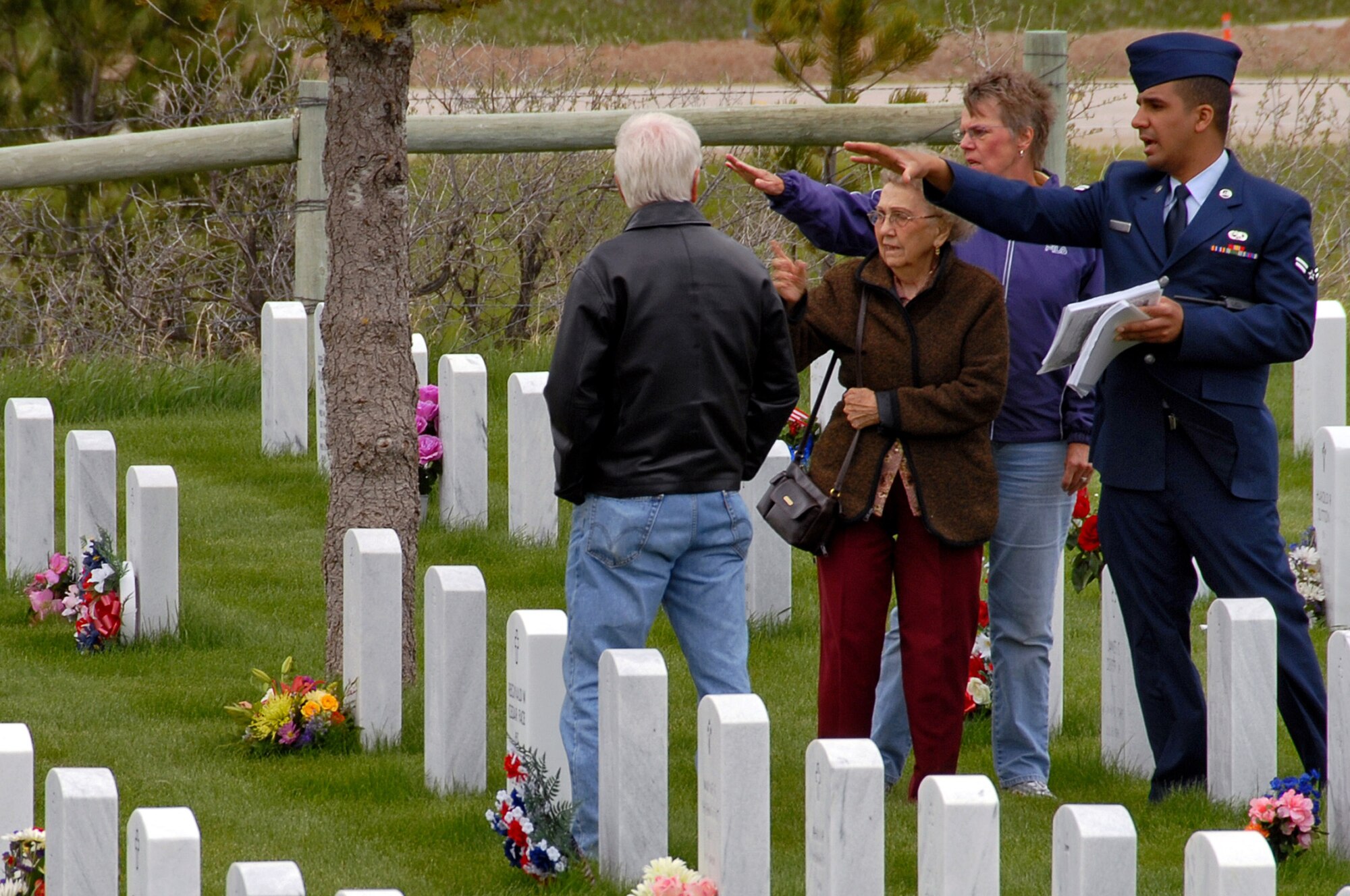 Airman 1st Class Brian Taylor, 28th Munitions Squadron armament apprentice, locates graves of fallen military members for friends and family at the Black Hills National Cemetery, S.D., May 25. During the Memorial day weekend 114 people from Ellsworth volunteered to help the cemetery. (U.S. Air Force photo/Senior Airman Marc I. Lane)
