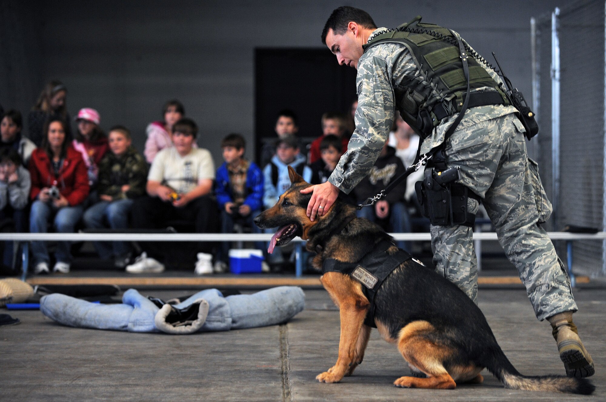 Staff Sgt. Jeremy Nichols, 28th Security Forces Squadron military working dog handler, prepares for a demonstration at the PRIDE hangar during a tour on May 22. Sixty fifth grade students from Newcastle Elementary School, Wyo., visited Ellsworth to learn more about the Air Force. (U.S. Air Force photo/Senior Airman Marc I. Lane)