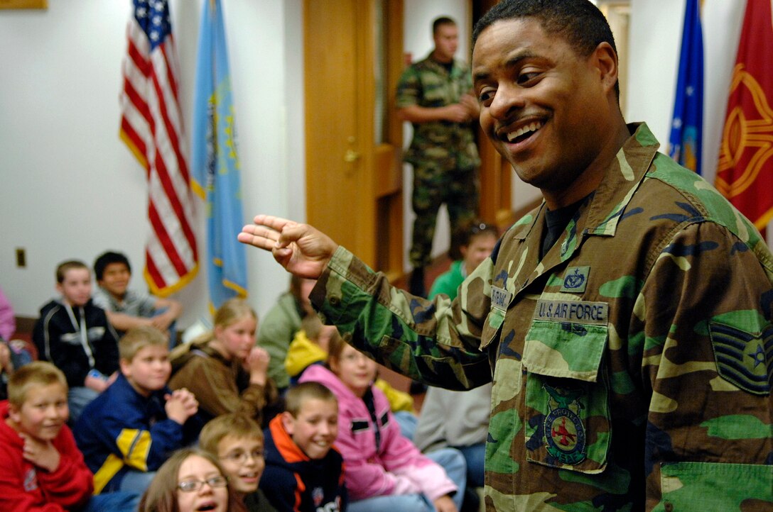 Tech. Sgt. Lorenzo Bell Thomas, 28th Civil Engineer Squadron fire and emergency services station captain, describes the difference between emergency tones used inside the fire department during a tour on May 22. Sixty fifth grade students from Newcastle Elementary School, Wyo., visited Ellsworth to learn more about the Air Force. (U.S. Air Force photo/Senior Airman Marc I. Lane)