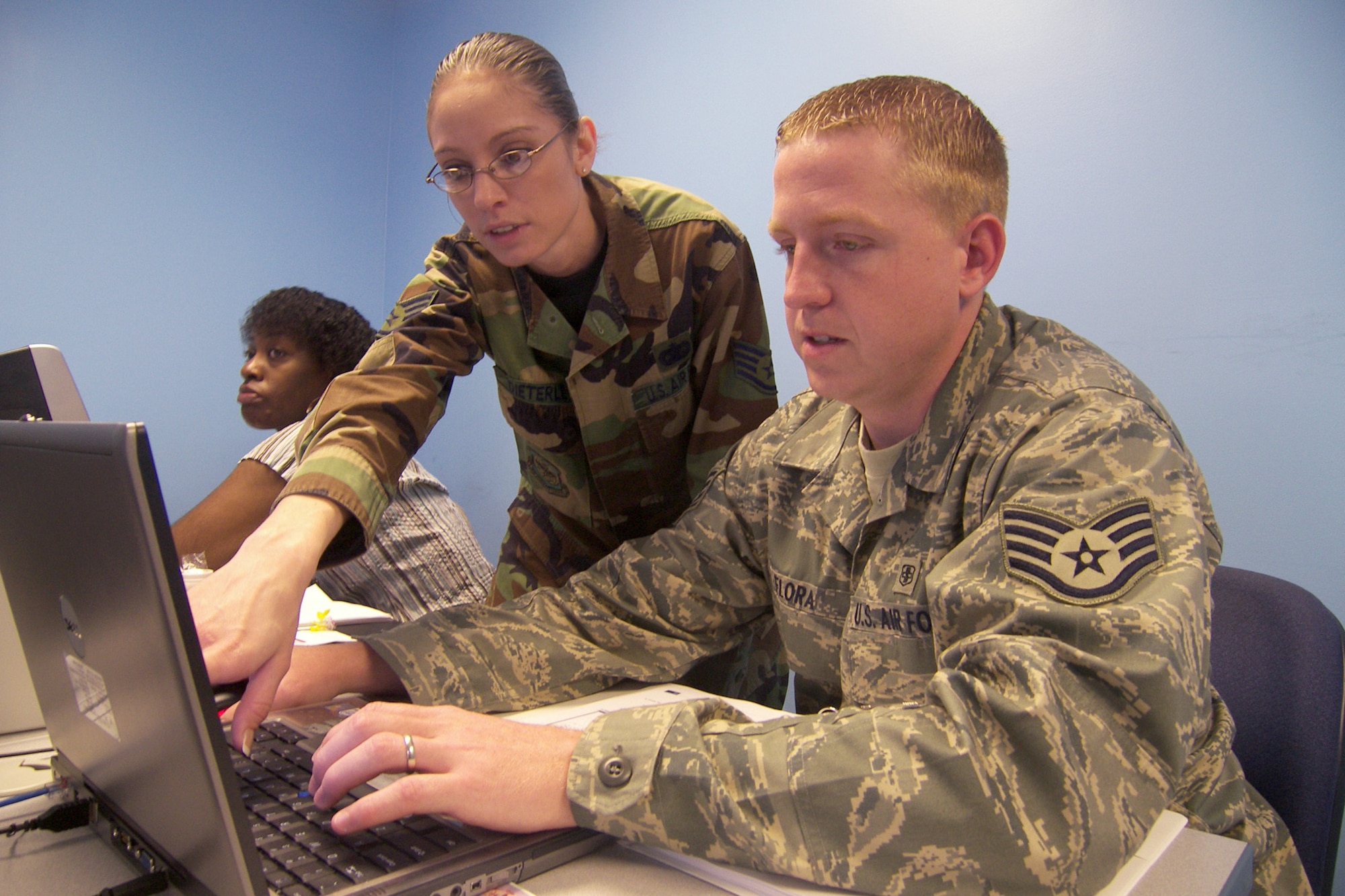 Staff Sgt. Angie Dieterle, Information Technology Training instructor from Air Mobility Command at Scott Air Force Base, Ill., shows Staff Sgt. Blake Flora, 436th Medical Support Squadron, how to operate Windows SharePoint Server, while Regina Ray, 436th Maintenance Squadron, observes May 16 here. SharePoint is software that powers the relatively-new Enterprise Information Management program. More commonly called EIM, the program provides a way for common access card holders to share files online within their organization and other organizations across the wing and command from any computer worldwide with CAC access. (U.S. Air Force photo/Master Sgt. Melissa Phillips)   
