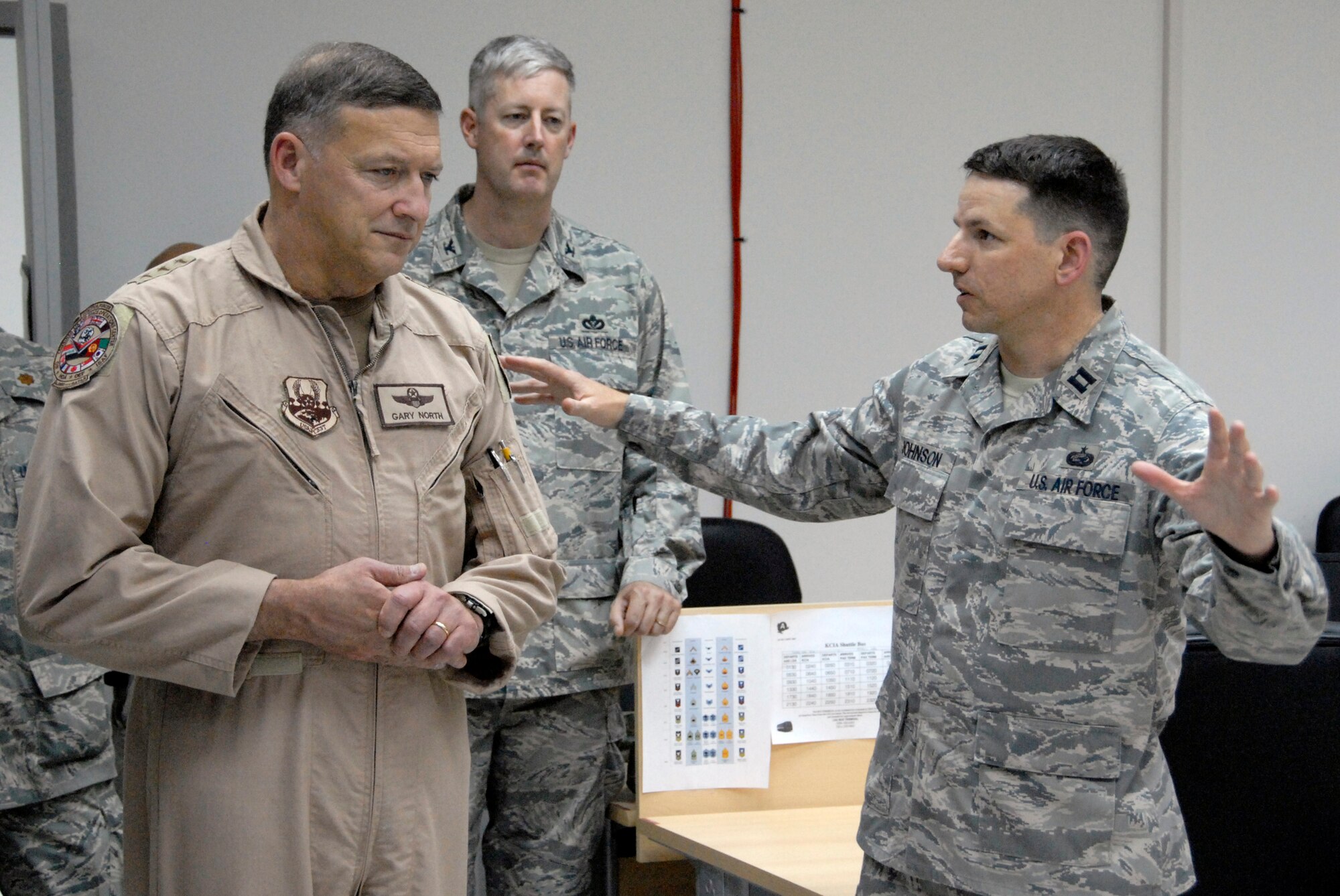 SOUTHWEST ASIA -- Captain Robert Johnson (right), from the 386th Expeditionary Force Support Squadron, briefs Lt. Gen. Gary North, the Ninth Air Force and Combined Forces Air Component Commander for U.S. Central Command, about the Deployment Control Center May 24, 2008 on an air base in the Persian Gulf Region. General North wrapped up a nine-day tour throughout the U.S. Air Forces Central area of responsibility to welcome recently deployed Airmen. He spoke with Airmen about the different mission sets they perform and to the level of proficiency and consistency at which Airmen execute those mission sets. Captain Johnson is deployed from the Air Force Personnel Center out of Randolph Air Force Base, Texas. (U.S. Air Force photo/ Staff Sgt. Patrick Dixon)