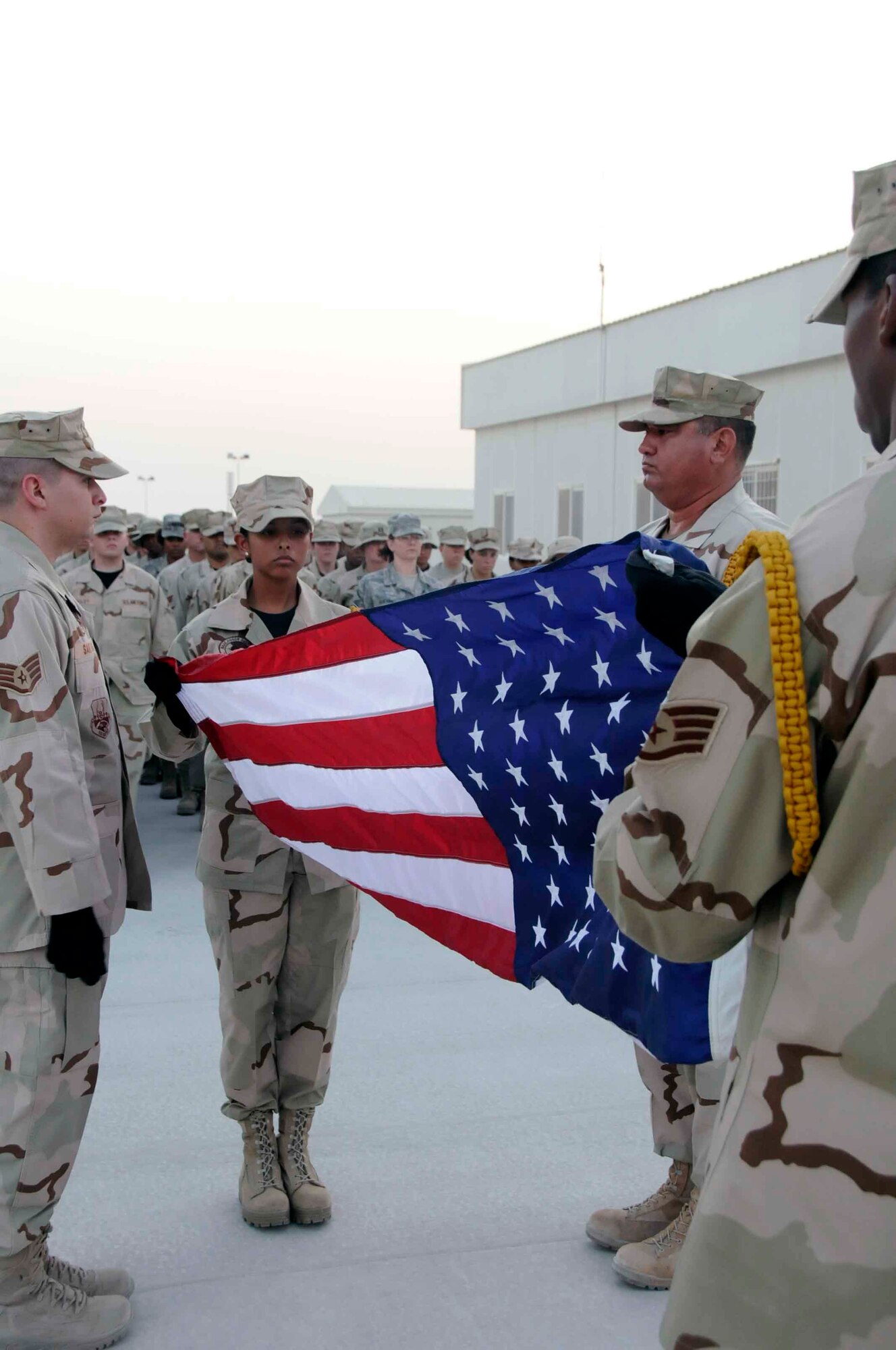 SOUTHWEST ASIA—The 379th Air Expeditionary Wing honor guard commences the retreat ceremony by folding the U.S. flag May 26. The retreat ceremony was held in honor of Memorial Day. (U.S. Air Force photo/Senior Airman Domonique Simmons)
