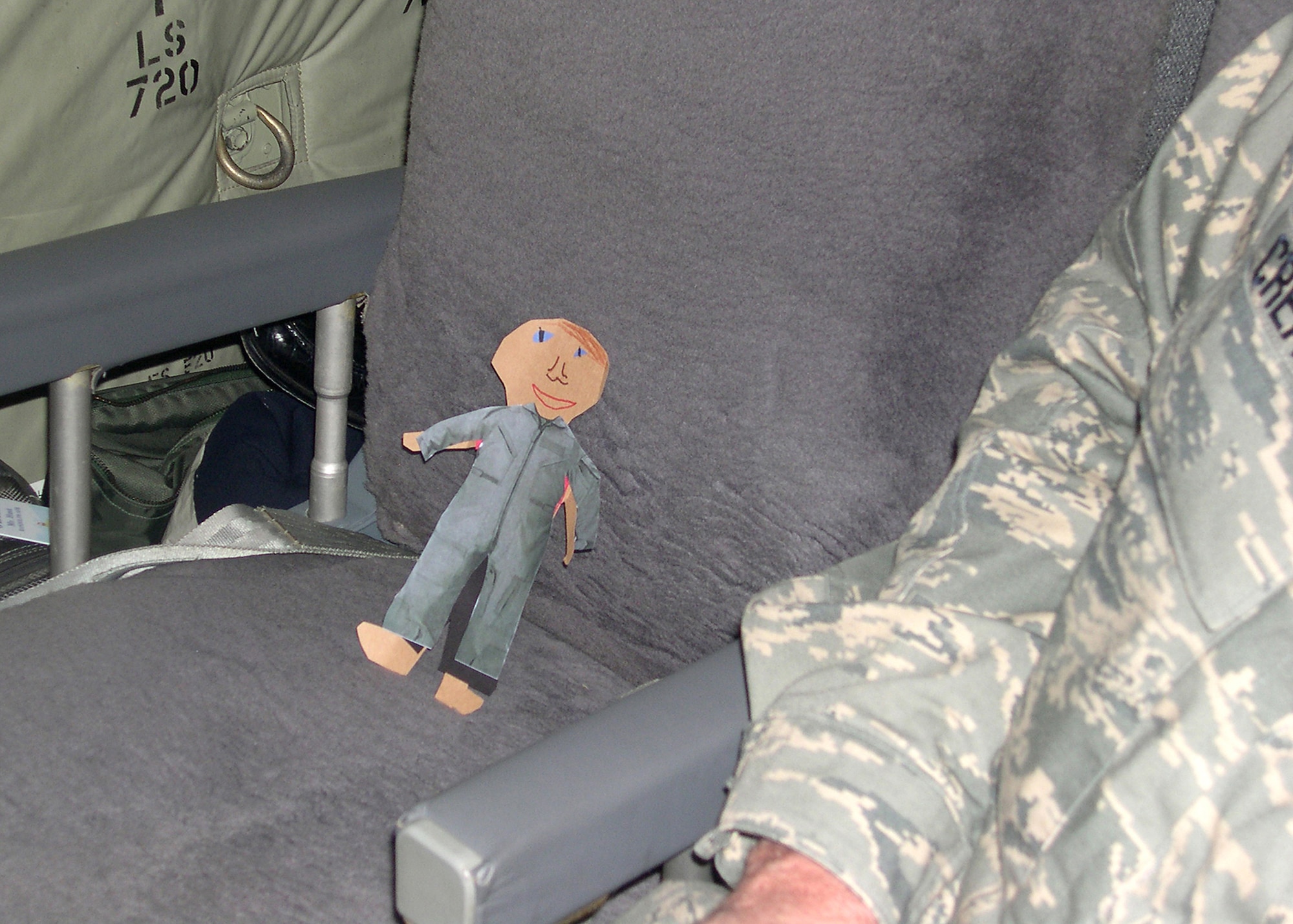 Flat Stanley returns home in a C-17 cargo aircraft, wearing a new customized flight suit given to him by attendees of a conference in February at Luke Air Force Base, Ariz. Brig. Gen. Suzanne Vautrinot, Air Force Recruiting Service commander, and her husband Bill Keller received a letter and the paper doll in February from their niece, Nikki, who lives in Wisconsin. Nikki requested her aunt and uncle assist her with a second-grade project by taking Flat Stanley with them on trips and writing to her about the doll’s adventures. Since 1995, the Flat Stanley Project has become a popular way for teachers to instruct letter writing, inspire reading and introduce young students to geography. (U.S. Air Force photo)