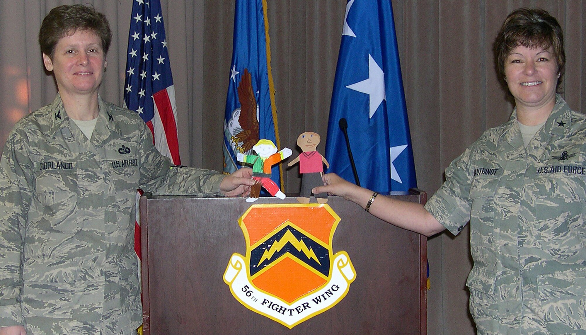 Brig. Gen. Suzanne Vautrinot, right, and Col. Theresa Giorlando pose with their Flat Stanley dolls at the Air Education and Training Command Commanders Conference in February at Luke Air Force Base, Ariz. The Air Force Recruiting Service commander and AETC directorate of communication, respectively, took part in the Flat Stanley Project, which is a popular way for teachers to instruct letter writing, inspire reading and introduce elementary school students to geography. (U.S. Air Force photo)