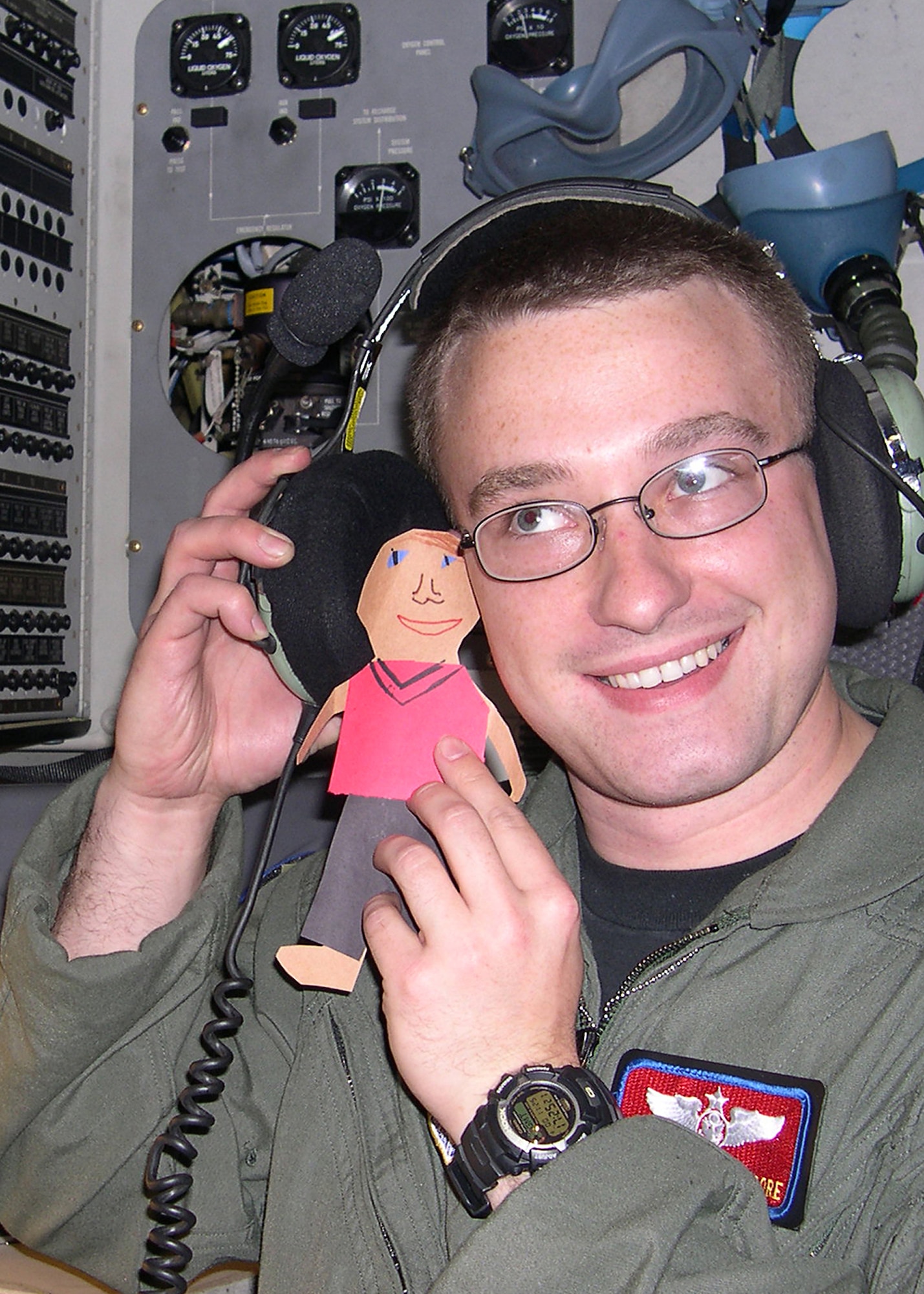 An Air Force C-17 Globemaster III crewmember shows Flat Stanley listening to pilot communications during a flight Feb. 24 to Luke Air Force Base, Ariz. Brig. Gen. Suzanne Vautrinot, Air Force Recruiting Service commander, and her husband Bill Keller received a letter in February from their niece, Nikki, containing the paper doll. Nikki requested the couple assist her with a second-grade project by taking Flat Stanley with them on trips and writing to her about the doll’s adventures. Since 1995, the Flat Stanley Project has become a popular way for teachers to instruct letter writing, inspire reading and introduce elementary students to geography. (U.S. Air Force photo)