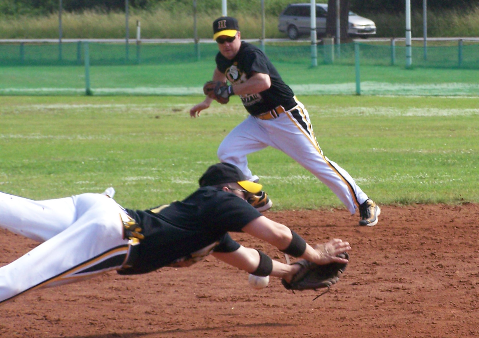 William McMillan, Lakenheath Men's Varsity Softball team, dives for a ball during a game against the Spangdahlem Sabers May 24 at Camp Darby, Italy. The Lakenheath team beat the Sabers during Camp Darby's European Open Softball tournament. The men’s team took fifth place and the Lakenheath Women's Varsity team took fourth place in the tournament. (U.S. Air Force photo by Staff Sgt. Vanessa Young)