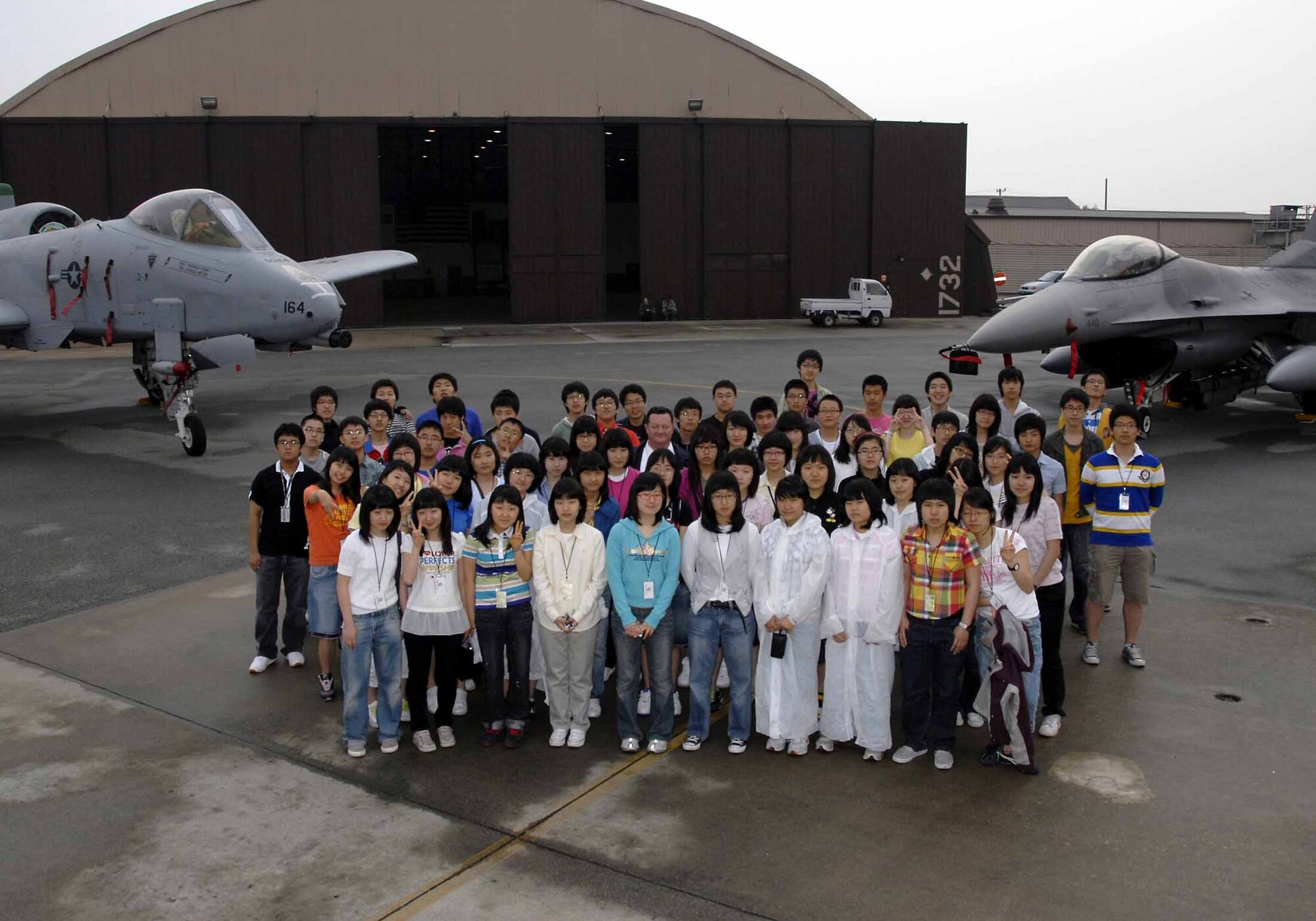 OSAN AIR BASE, Republic of Korea -- U.S. Forces Korea's English Camp participants pose for a photo during a tour of the base May 21. Sixty Korean first-year high school students participated in USFK’s annual Good Neighbor English Camp. The event is designed to introduce young Korean students to USFK personnel, mission and policies, through a series of organized, interactive and educational activities conducted on USFK installations. (U.S. Air Force photo/Senior Airman Christopher Boitz)