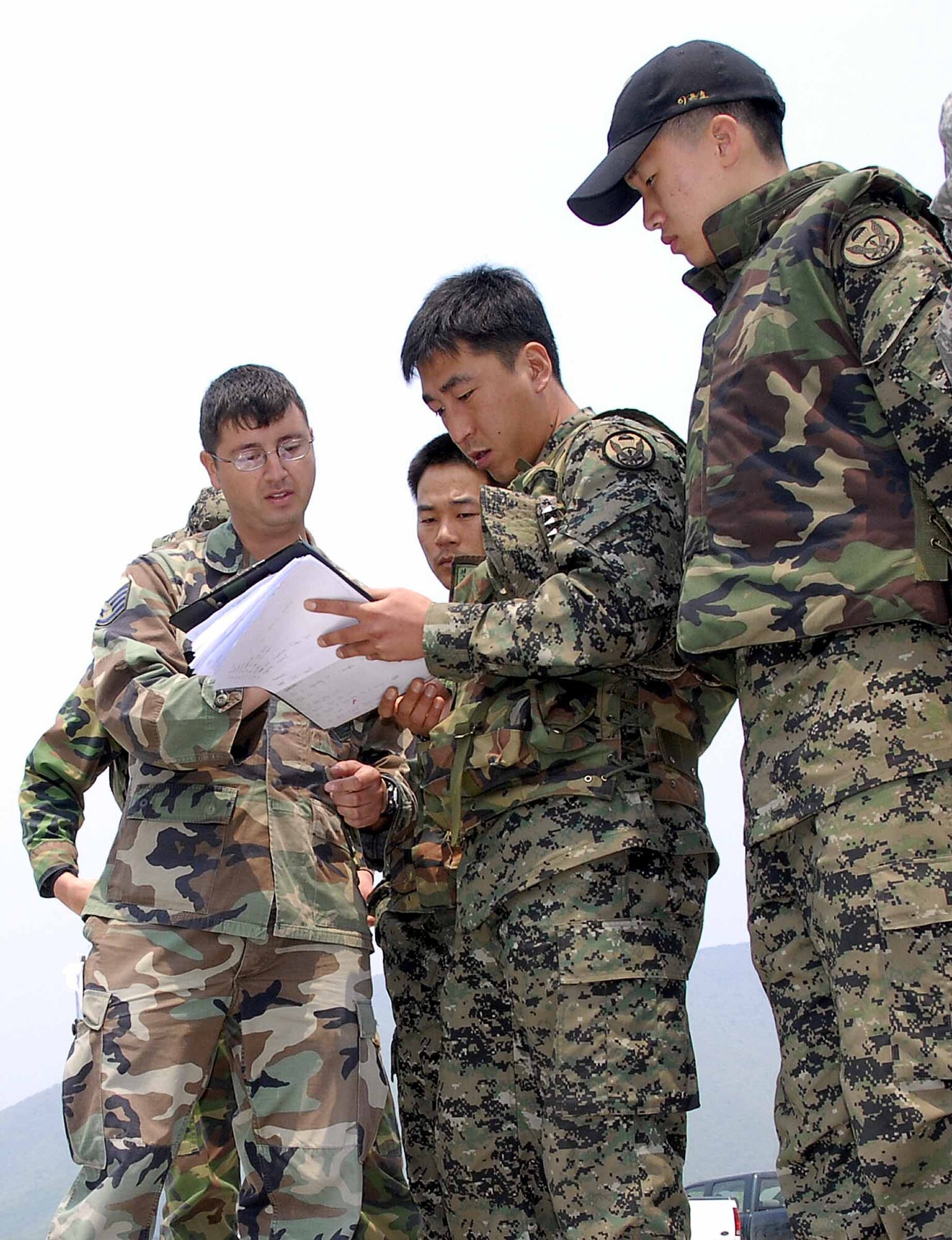 Staff Sgt. Shawn Christensen, 607th Air Support Operations Group, goes over procedures to call in close air support missions with Republic of Korea Army personnel during a live-fire training exercise May 21.  Military units from both countries took part in the five-day training to enhance understanding of conventional close-air support procedures and other warfighting capabilities. (U.S. Air Force photo/Staff Sgt. Scottie McCord)