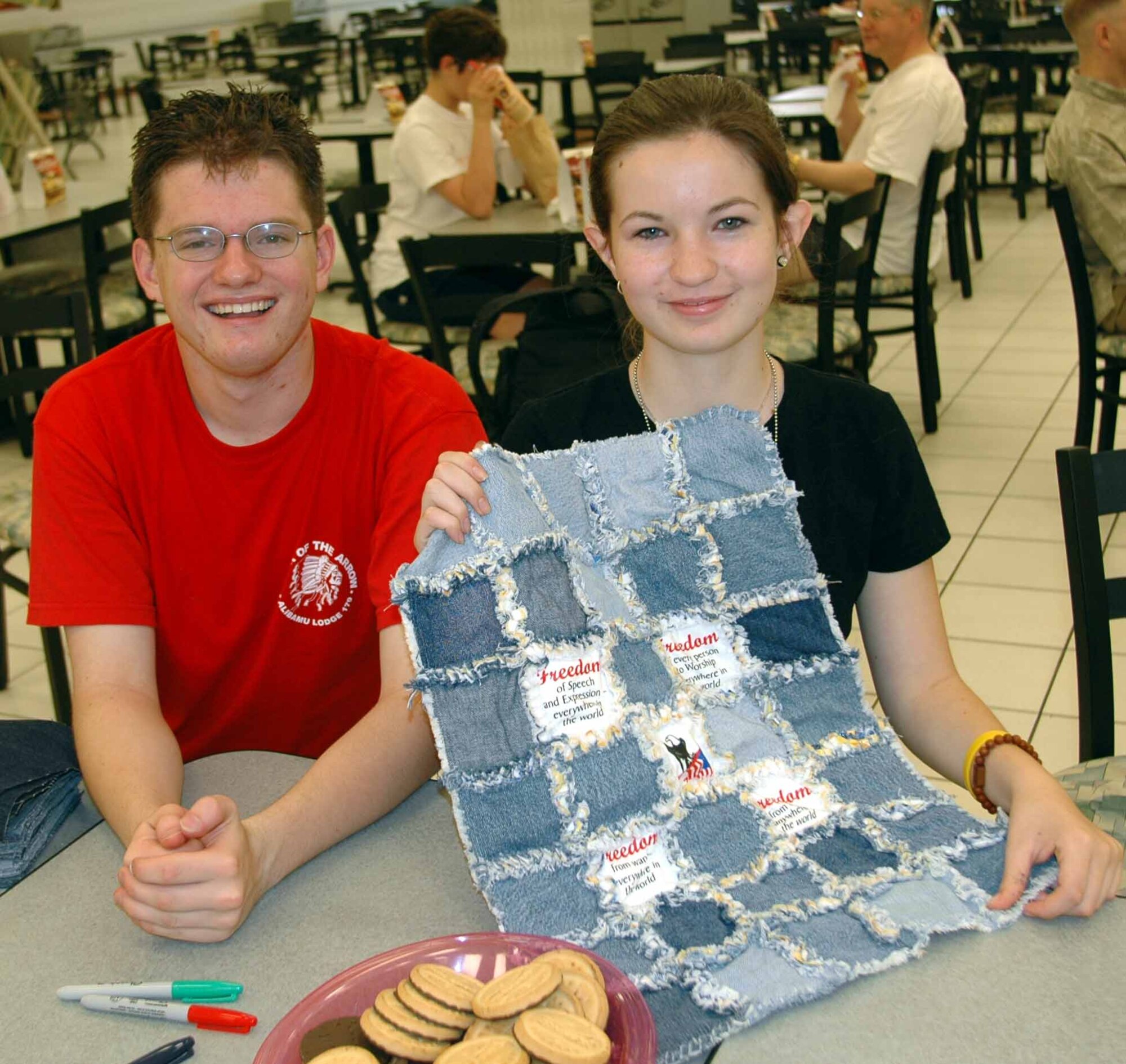 Naomi McDonald and Patrick Cassidy, event coordinators, show a portion of a the jean quilt. Four freedom gratitude quilts will be given to wounded servicemembers returning from Afghanistan and Iraq. (U.S. Air Force photo/Staff Sgt. Candy Knight)
