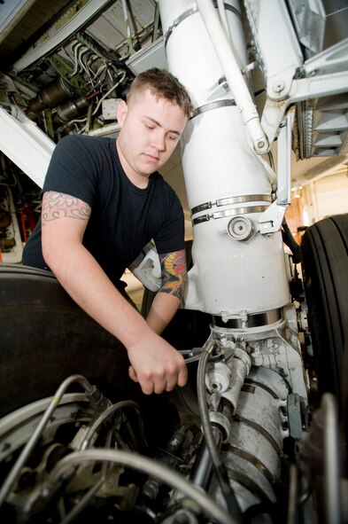 Senior Airman Patrick Savage, 718th Aircraft Maintenance Squadron, tightens the main landing gear centering cylinder on an E-3 Airborne Warning and Control System at Elmendorf Air Force Base, Alaska, May 12, 2008. Airman Savage is deployed from Kadena Air Base, Japan to participate in Northern Edge 08.  (U.S. Air Force photo/Airman 1st Class Jonathan Steffen)