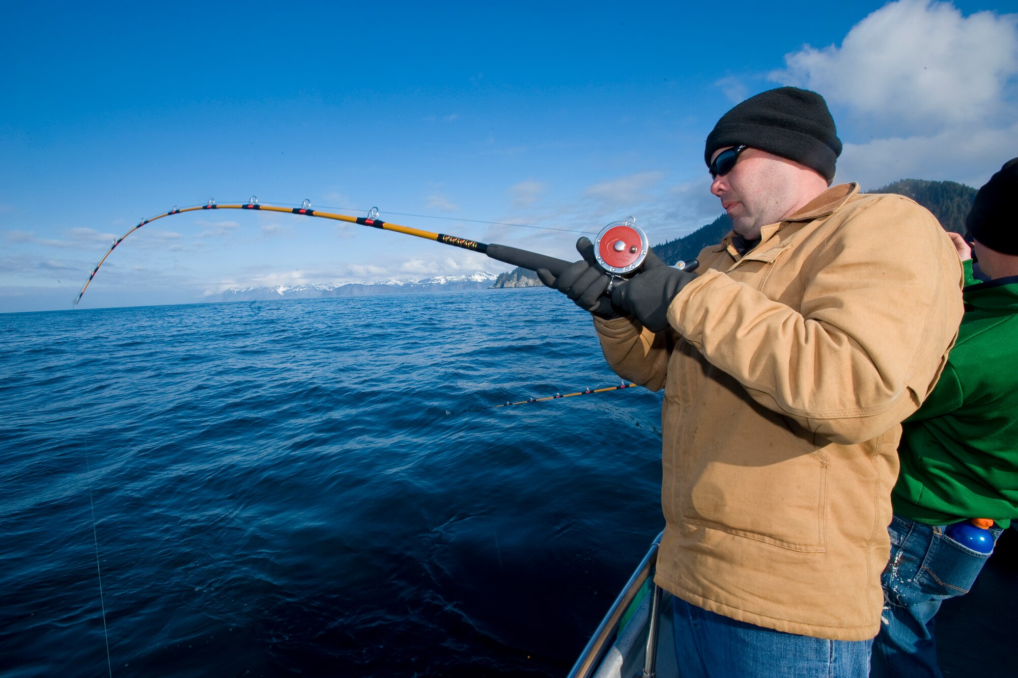 Tech. Sgt. Samuel Harris, 3rd Civil Engineer Squadron, reels in a halibut early in the tournament. More than 200 servicemembers participated in the tournament. (U.S. Air Force photo/Master Sgt. Keith Brown)