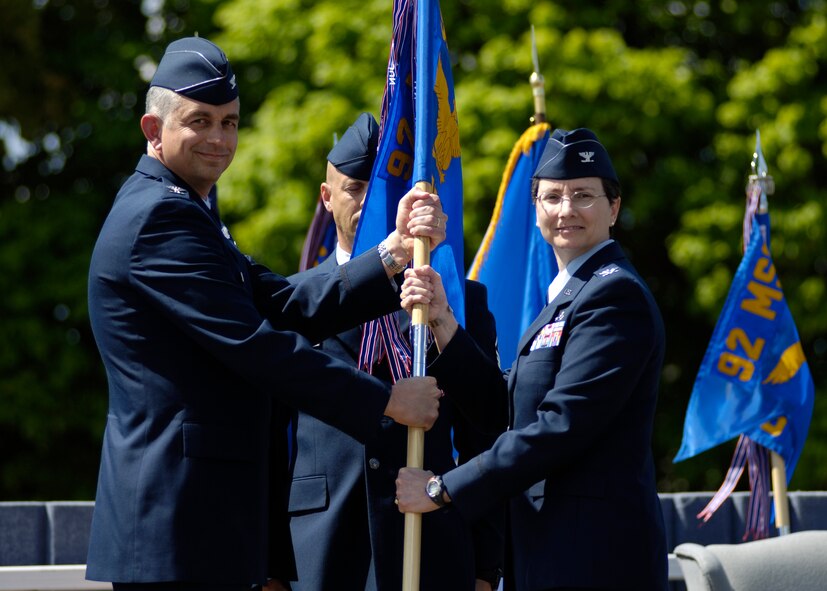 FAIRCHILD AIR FORCE BASE, Wash. -- Col. Roger Watkins, 92nd Air Refueling Wing vice commander, presents Col. Suzanne Filion, 92nd Mission Support Group commander, with the group guideon during the 92nd MSG change-of-command ceremony here May 27. (U.S. Air Force photo / Staff Sgt. Chad Watkins)   