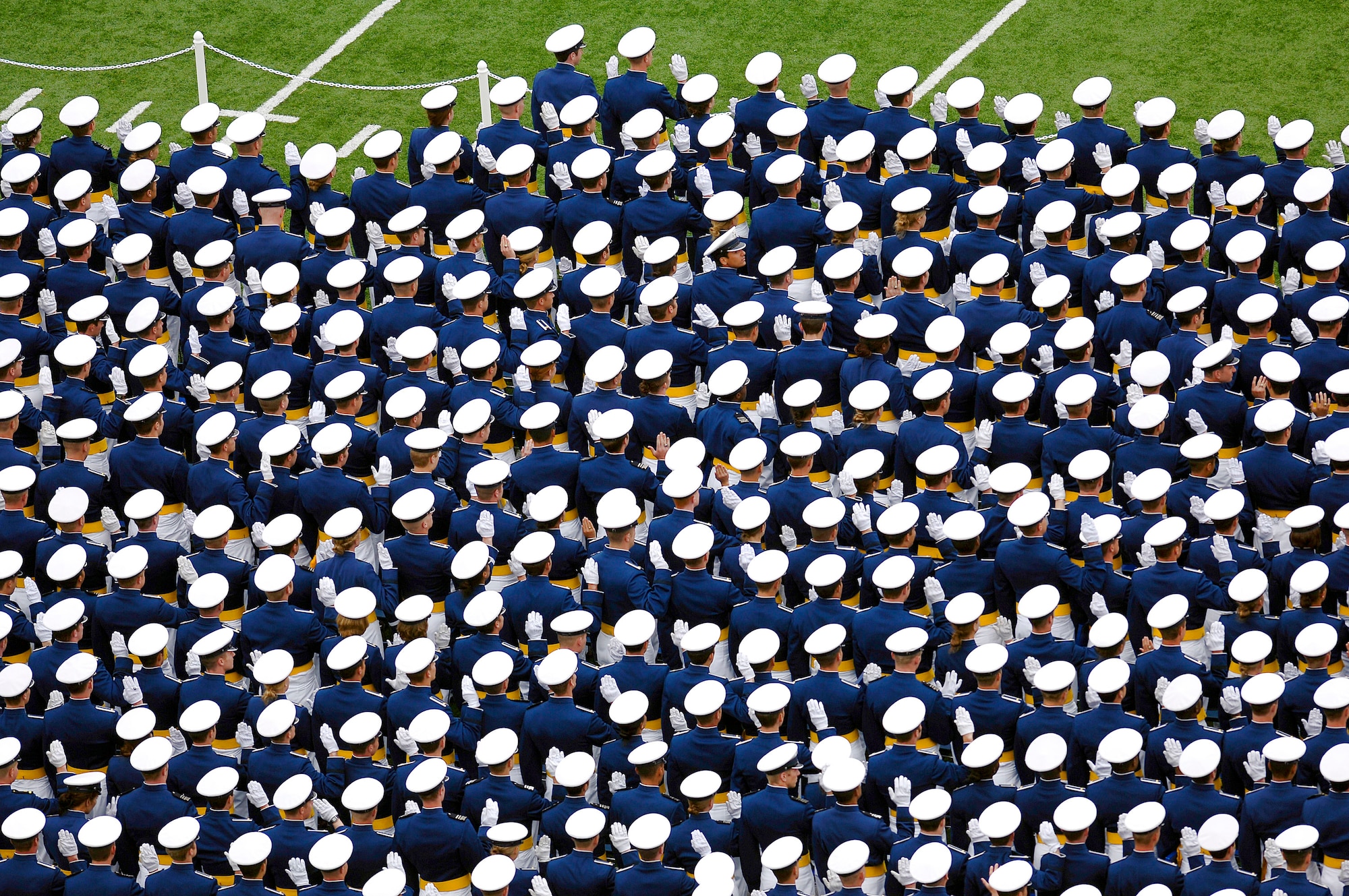 Newly graduated second lieutenants recite the Oath of Office, followed by the traditional hat toss during the U.S. Air Force Academy Class of 2008 graduation ceremony at Falcon Stadium May 28.  (U.S. Air Force photo/David Armer)