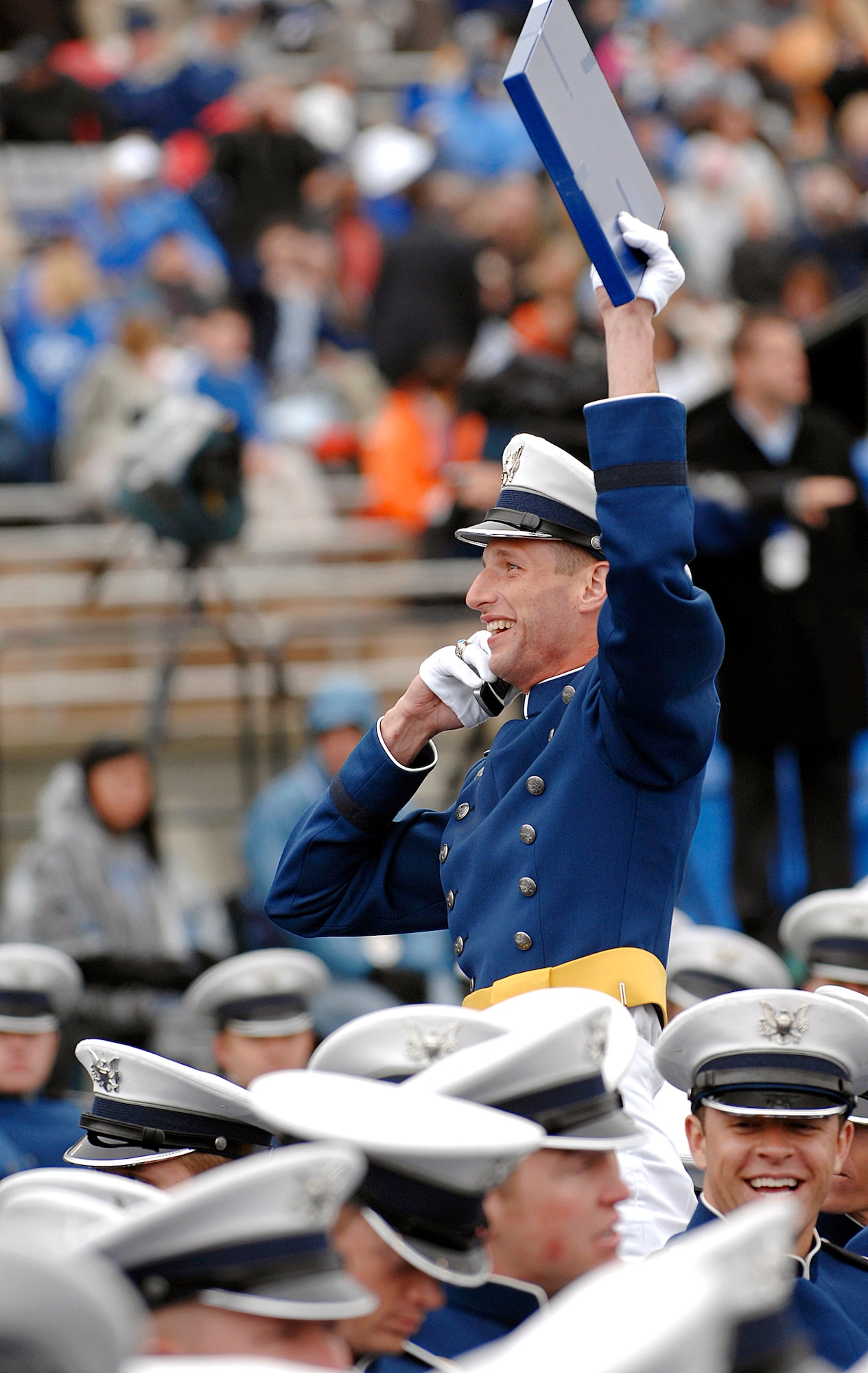 A cadet makes sure his family sees his diploma during Academy Class of 2008 commencement ceremony at the U.S. Air Force Academy's Falcon Stadium on May 28.  (U.S. Air Force photo/Dave Ahlschwede)