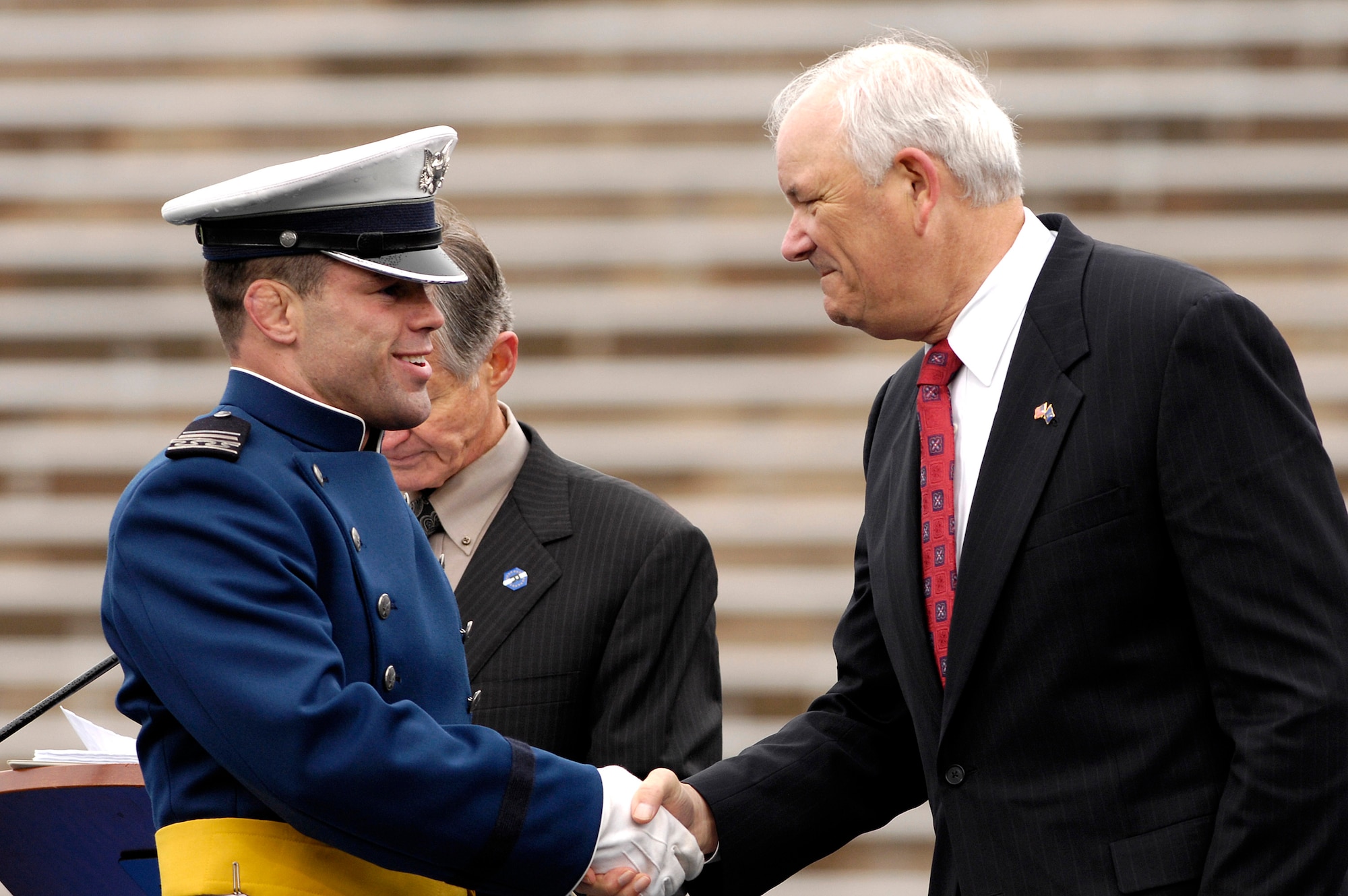 During the U.S. Air Force Academy Class of 2008 graduation ceremony, Secretary of the Air Force Michael W. Wynne congratulates newly commissioned 2nd Lt. Anthony Dorward at Falcon Stadium May 28. The Academy commissioned 1,012 second lieutenants. (U.S. Air Force photo/Mike Kaplan)