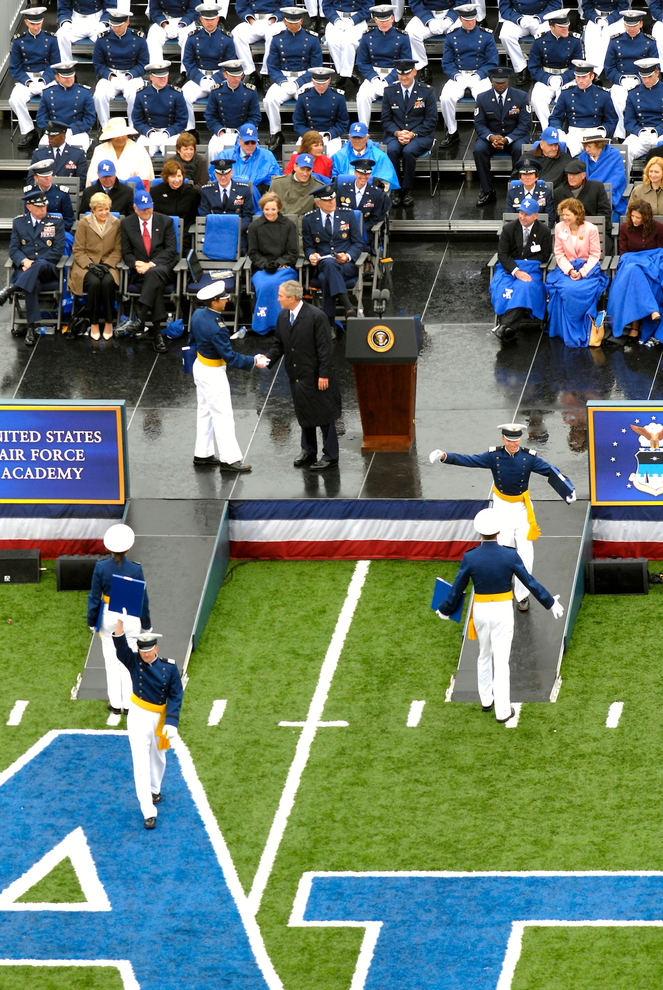 President George W. Bush congratulates a newly-commissioned second lieutenant during the 2008 U. S. Air Force Academy graduation ceremony at Falcon Stadium May 28. (U.S. Air Force photo/David Armer)