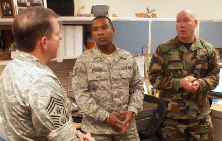 Tech. Sgt. Reginald D. Frazier and Master Sgt. John P. Draven brief Chief Master Sgt. of the Air Force Rodney J. McKinely May 29 on AEF 7-day ops during his visit to the Air Force Personnel Center here at Randolph Air Force Base, Texas. (US Air Force photo/Master Sgt. Kat Bailey)