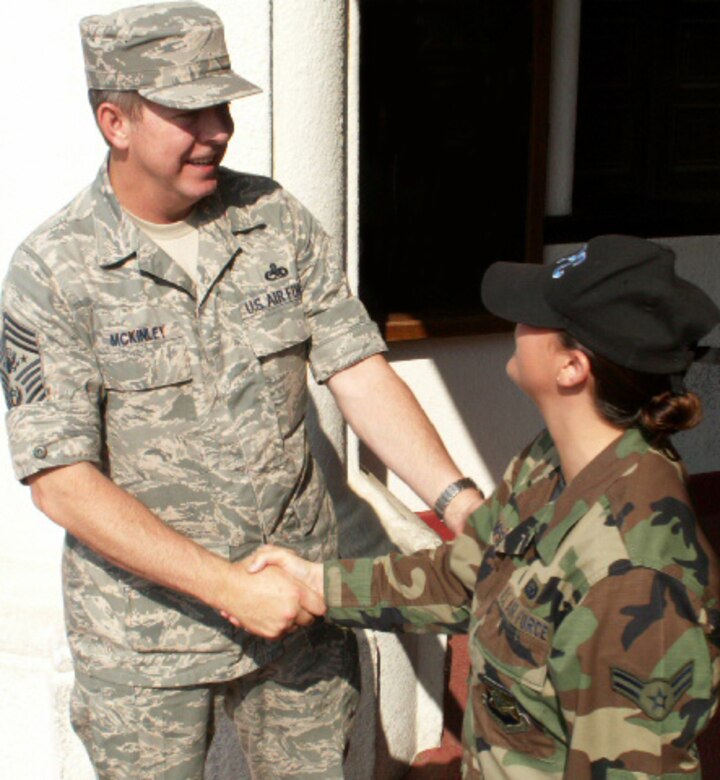Airman 1st Class Lillian Thompsett, a personnelist at the Air Force Personnel Center here, greets Chief Master Sgt. of the Air Force Rodney J. McKinley outside the Randolph Air Force Base theater. The chief attended AFPC's commander's call and spent the day visiting with Airmen and civilians from AFPC. (US Air Force photo/Master Sgt. Kat Bailey)
