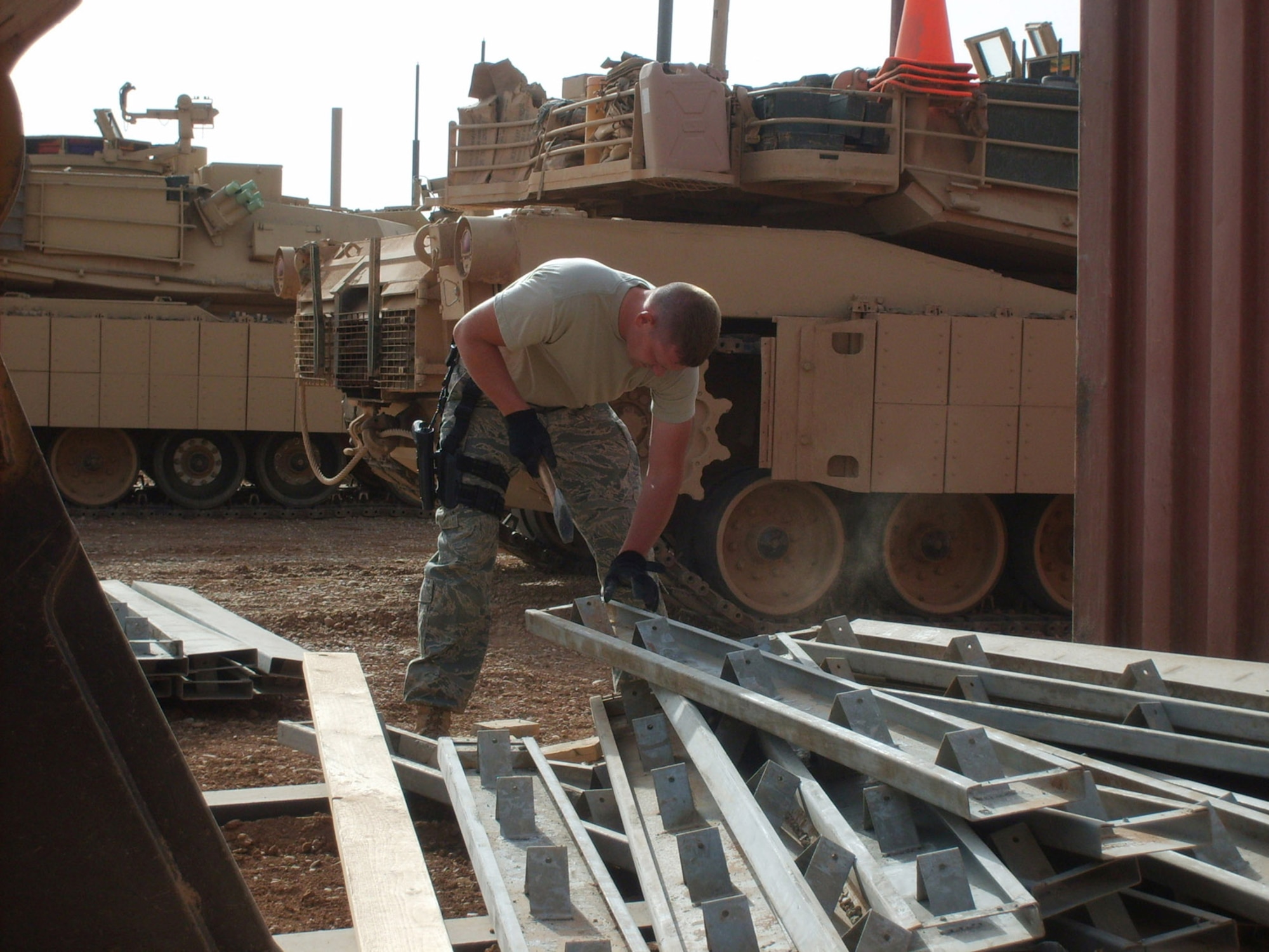 Staff Sgt. Josh Jeffreys cleans concrete forms after a cement pouring project at Forward Operating Base Caldwell, Iraq. The concrete forms are used in the process of making pads for the Army motorpool Soldiers. These pads will allow Soldiers to perform maintenance on their vehicles without having to be in the dirt and mud. Staff Sergeant Jeffreys is a heavy equipment operator with the 732nd Expeditionary Civil Engineer Squadron. (U.S. Air Force photo/Senior Airman Dan Smith) 