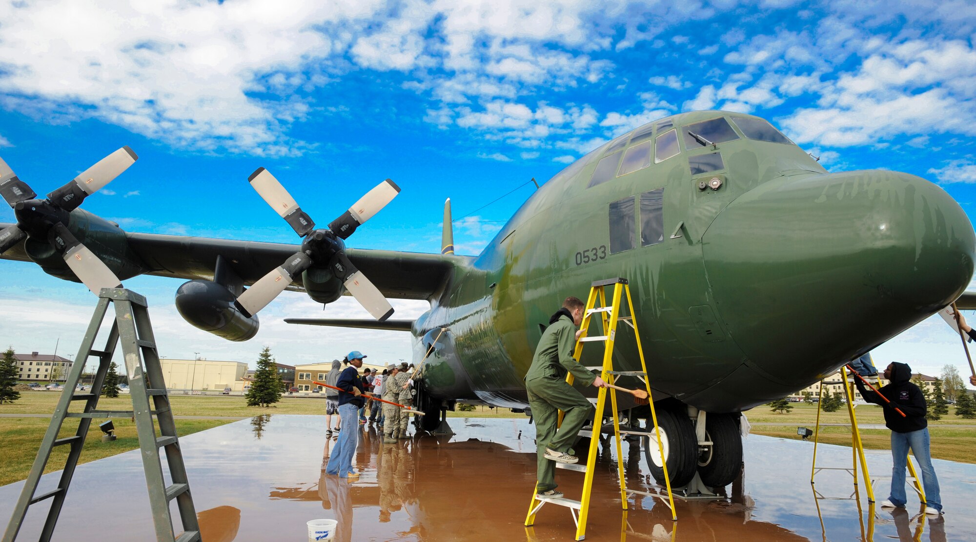Volunteers clean the static display of Heritage Park in front of the 3rd Wing Headquarters building May 22. The displays are cleaned biannually by volunteers every early summer and fall. (U.S. Air Force photo by Airman 1st Class Laura Turner)