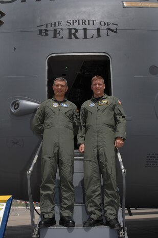 BERLIN, Germany - German air force airlift pilot Lt. Col. Marc Beutler (left) and U.S. Air Force airlift pilot Maj. Troy Lanich (right), both participants in the U.S.-German exchange pilot programs, met up here at the 2008 Berlin Air Show for a photo opportunity in front of the C-17 Globemaster III that Lt. Col Beutler flies with the 14th Ailift Squadron at Charleston Air Force Base, S.C. May 29.  Maj. Lanich has been assigned to the German air force Special Air Mission Wing for over a year and Lt. Col. Beutler has been assigned to the 14th AS for over three years. (U.S. Air Force photo by Tech Sgt. Corey Clements) (released)