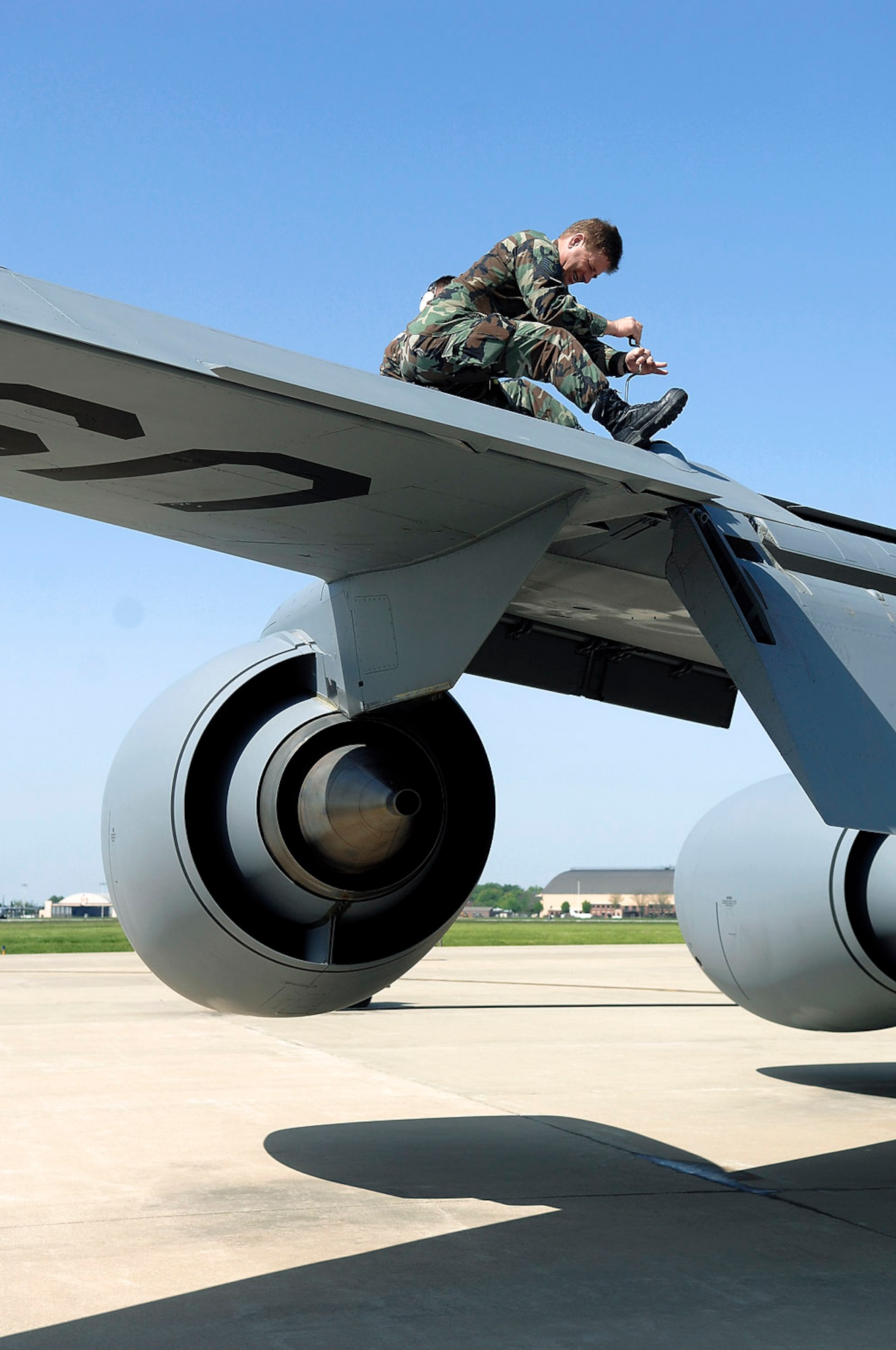Tech. Sgt. Kris Randolph removes a panel from the left wing of a KC-135R Stratotanker to remove some debris. Sergeant Randolph is a crew chief with the 126th Air Refueling Wing at Scott Air Force Base, Ill. (U.S. Air Force photo/Bennie J. Davis III)