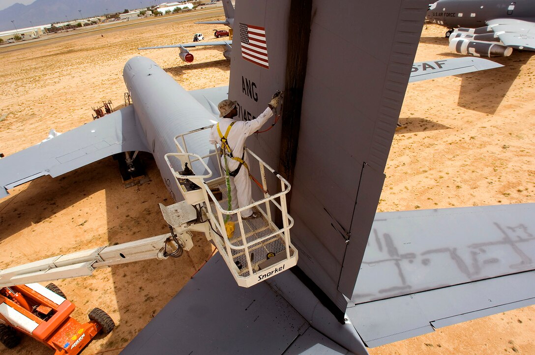 Juan Thomas sprays a protective sealant on the tail of a KC-135E Stratotanker to prepare the aircraft for storage and preservation at the Aerospace Maintenance and Regeneration Group storage site at Davis Monthan Air Force Base, Ariz. AMARG's mission has evolved beyond merely the storage and preservation of aircraft.  Today the center provides customer services including aircraft regeneration which means restoring aircraft to flying status, limited depot-level maintenance, parts reclamation, historic storage and disposal functions.  (U.S. Air Force photo/Bennie J. Davis III)