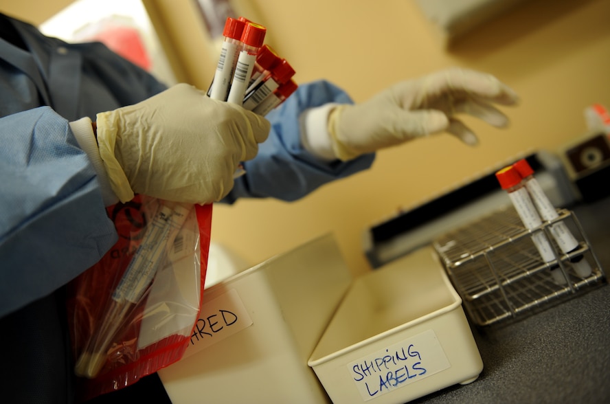 MOODY AIR FORCE BASE, Ga. -- Rose Finch, 23rd Medical Group laboratory technician, removes blood samples from a tray to send off for testing here May 29. Certain blood samples are sent to other facilities for more specialized procedures. (U.S. Air Force photo by Senior Airman Gina Chiaverotti)