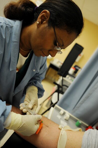MOODY AIR FORCE BASE, Ga. -- Alicia Hearn, a medical laboratory technician student from Valdosta Technical College, draws blood from Master Sgt. Tom Cochran, 23rd Aircraft Maintenance Squadron specialist section chief, at the laboratory here May 29. Blood is drawn at least once a year from military members for health screening. (U.S. Air Force photo by Senior Airman Gina Chiaverotti)