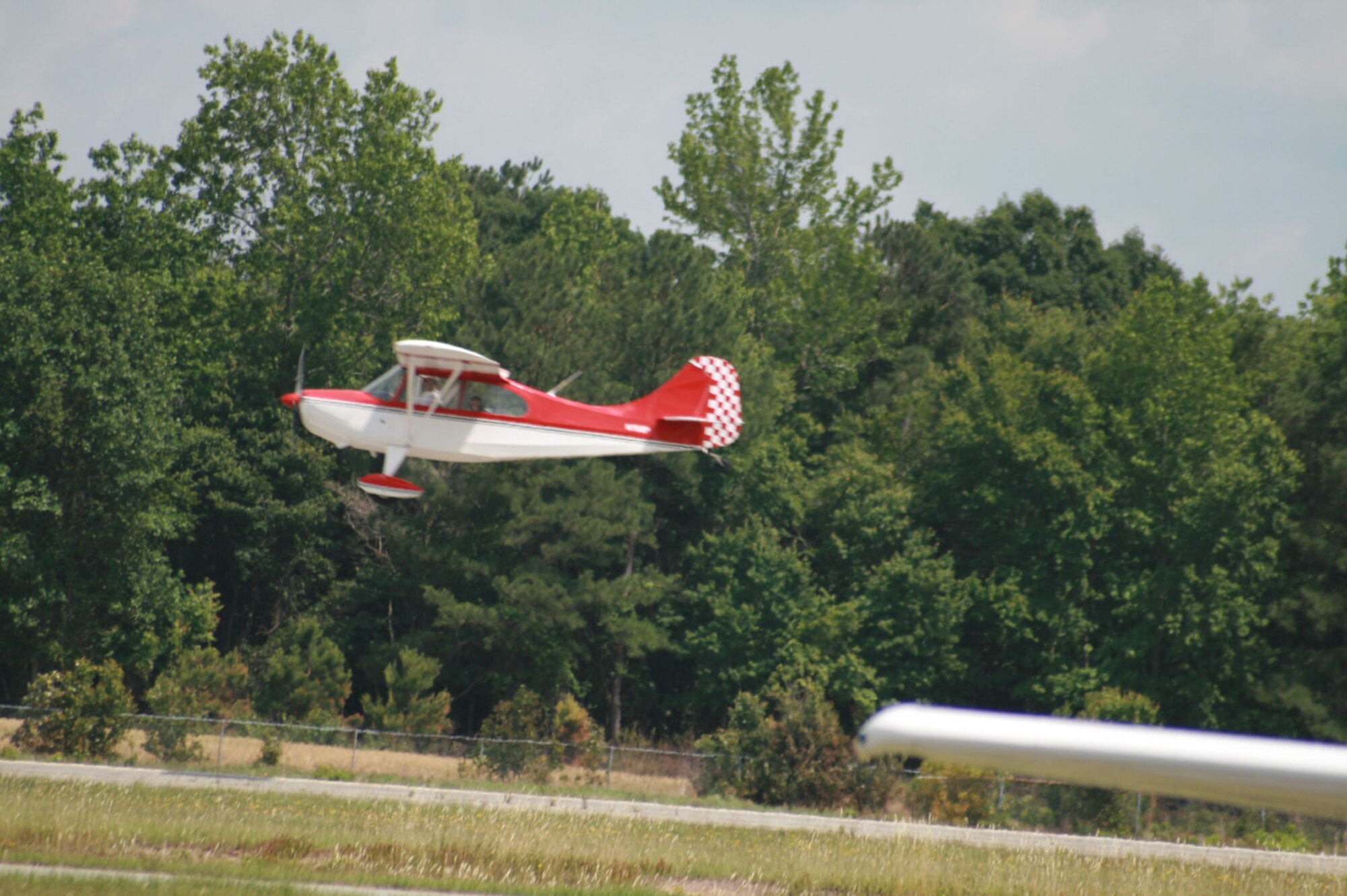 SEYMOUR JOHNSON AIR FORCE BASE, N.C. - Lieutenant. Col. James Jinnette, 335th Fighter Squadron commander, takes off in his Aeronca 7 Champion airplane during the Experimental Aircraft Association Young Eagles Day at the Goldsboro/Wayne County Municipal Airport May 24.  More than 80 base youth participated in the day's activity.  The EAA Young Eagles program was launched in 1992 to give interested young people an opportunity to go flying in a general aviation airplane. (U.S. Air Force photo by Staff Sgt. Les Waters)