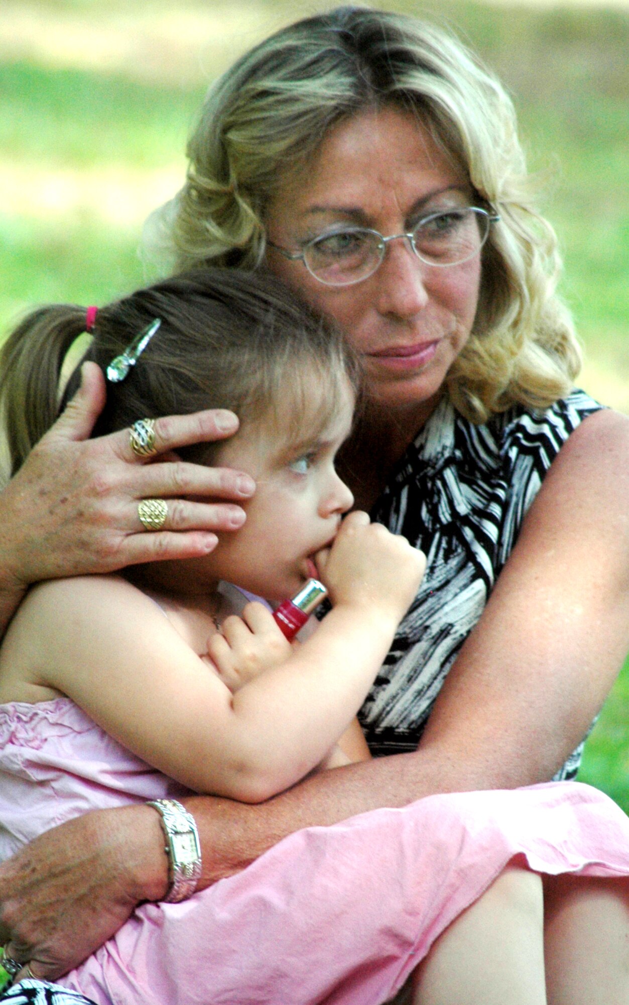 Kim Bounds holds her grand daughter Lauren Elizabeth Martin during the Camellia Garden Memorial Service. They attended the service to honor Alfred "Spike" Nicklow, Ms. Bounds father and Lauren's great grandfather. U. S. Air Force photo by Sue Sapp